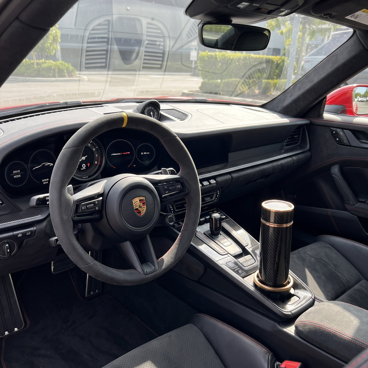 CarbonFlow Gold in the cupholder of a Porsche 992 GT3 RS, driver's view
