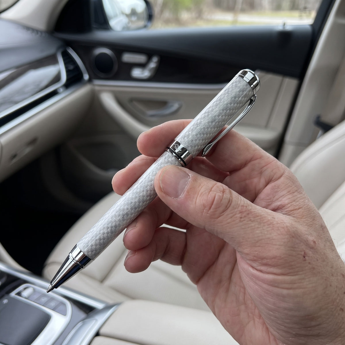 Holding the silver CarbonInk in the car