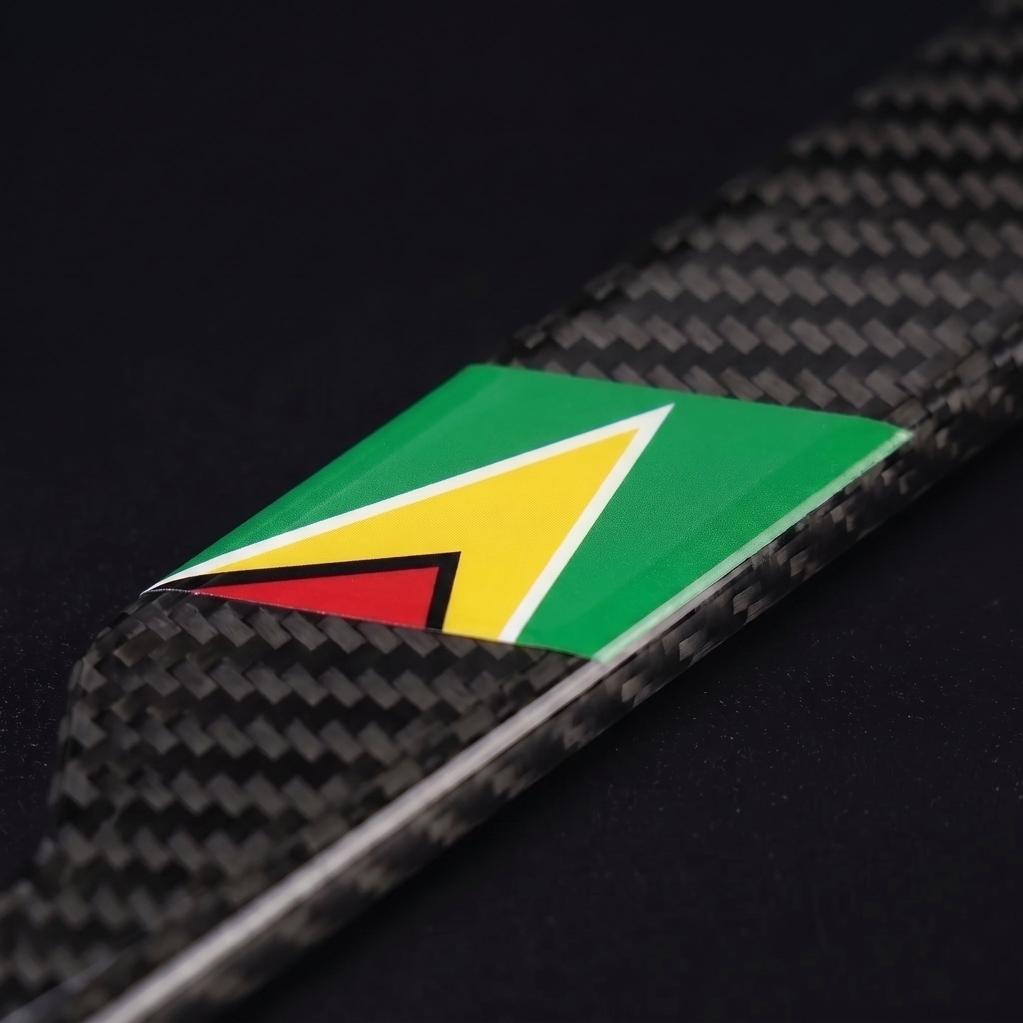Macro of the Guyana flag inlay on a PSF Carbon carbon fiber license plate frame