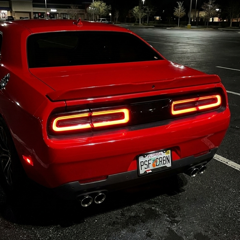 Egypt carbon plate frame on a red Dodge Challenger, taillights on
