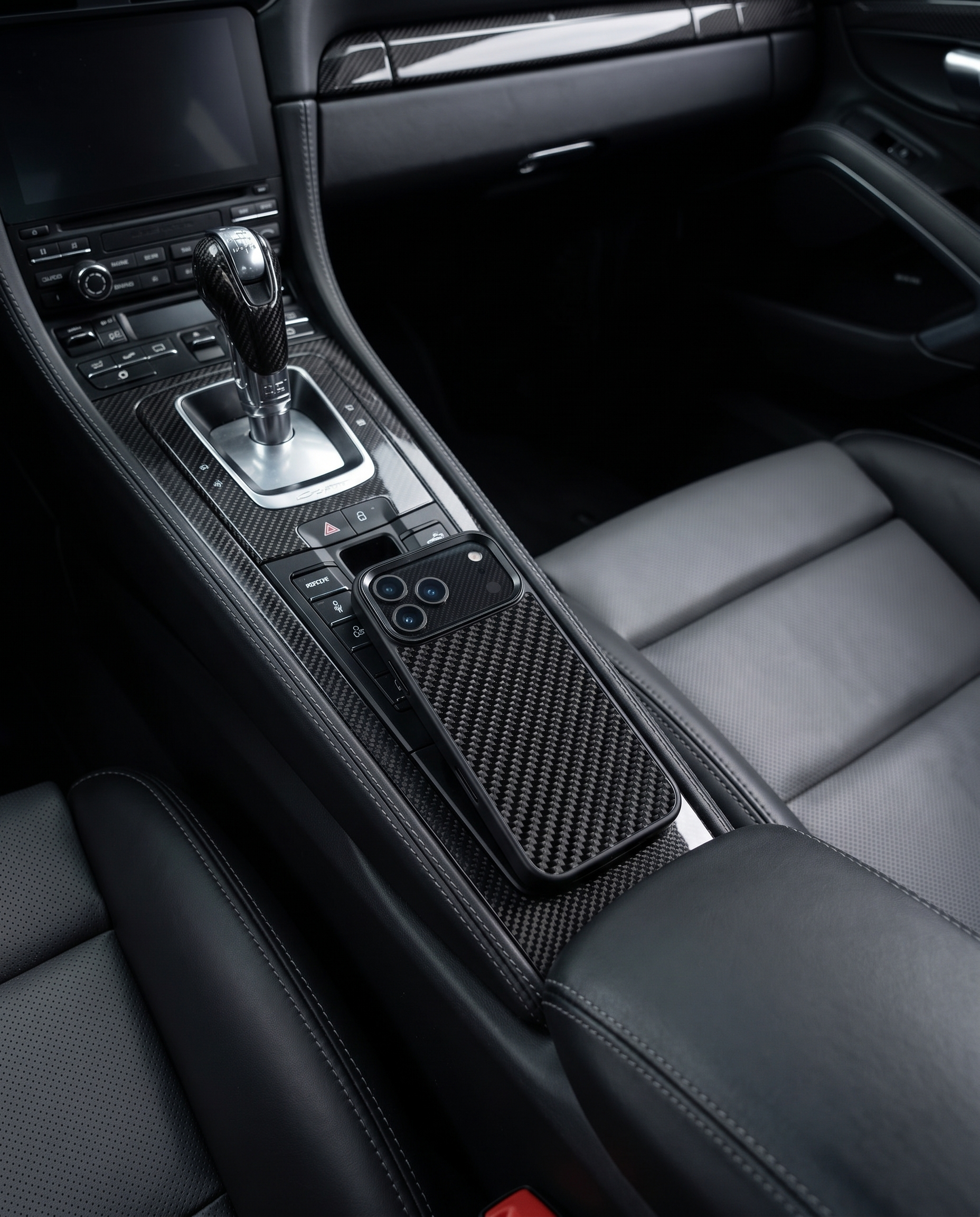 Black 3K carbon fiber iPhone case on sports car carbon center console