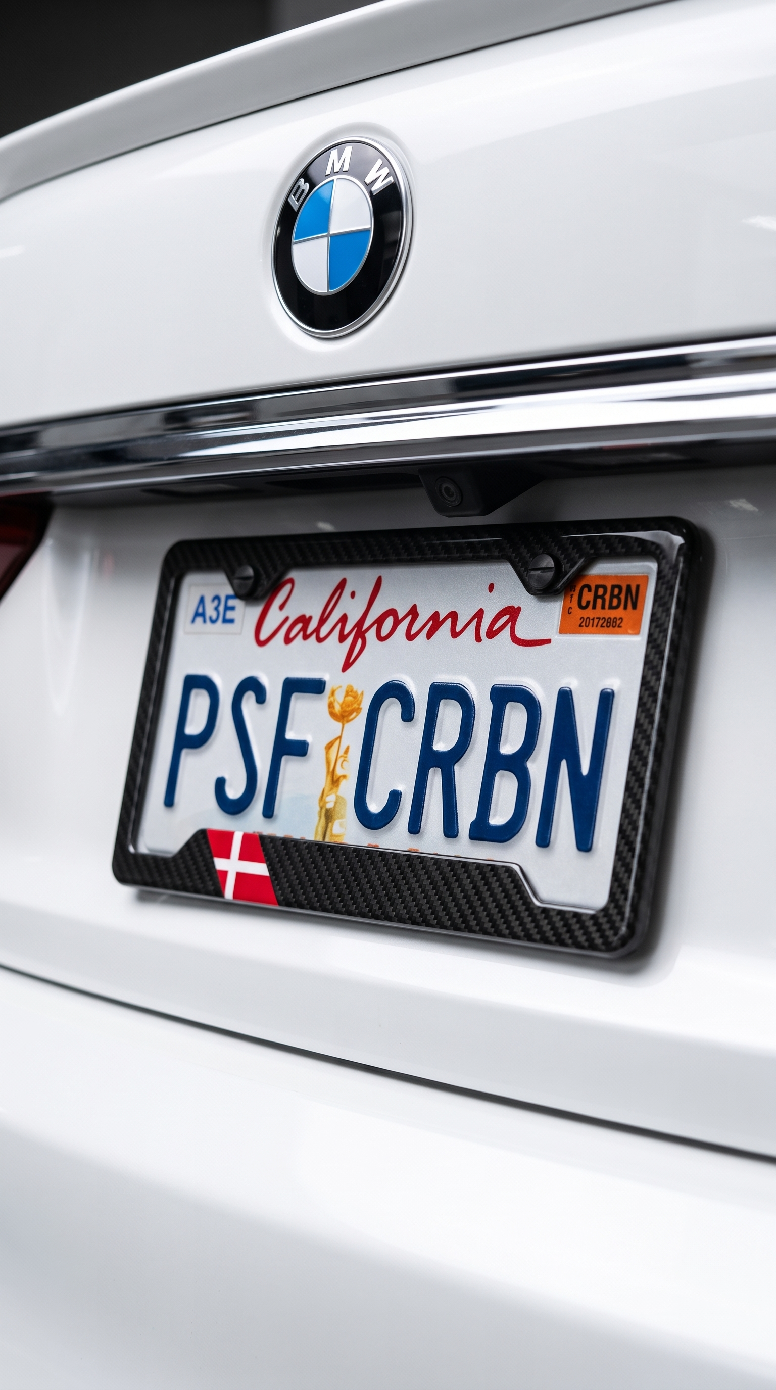 Denmark flag carbon fiber license plate frame close-up on white BMW 7 Series