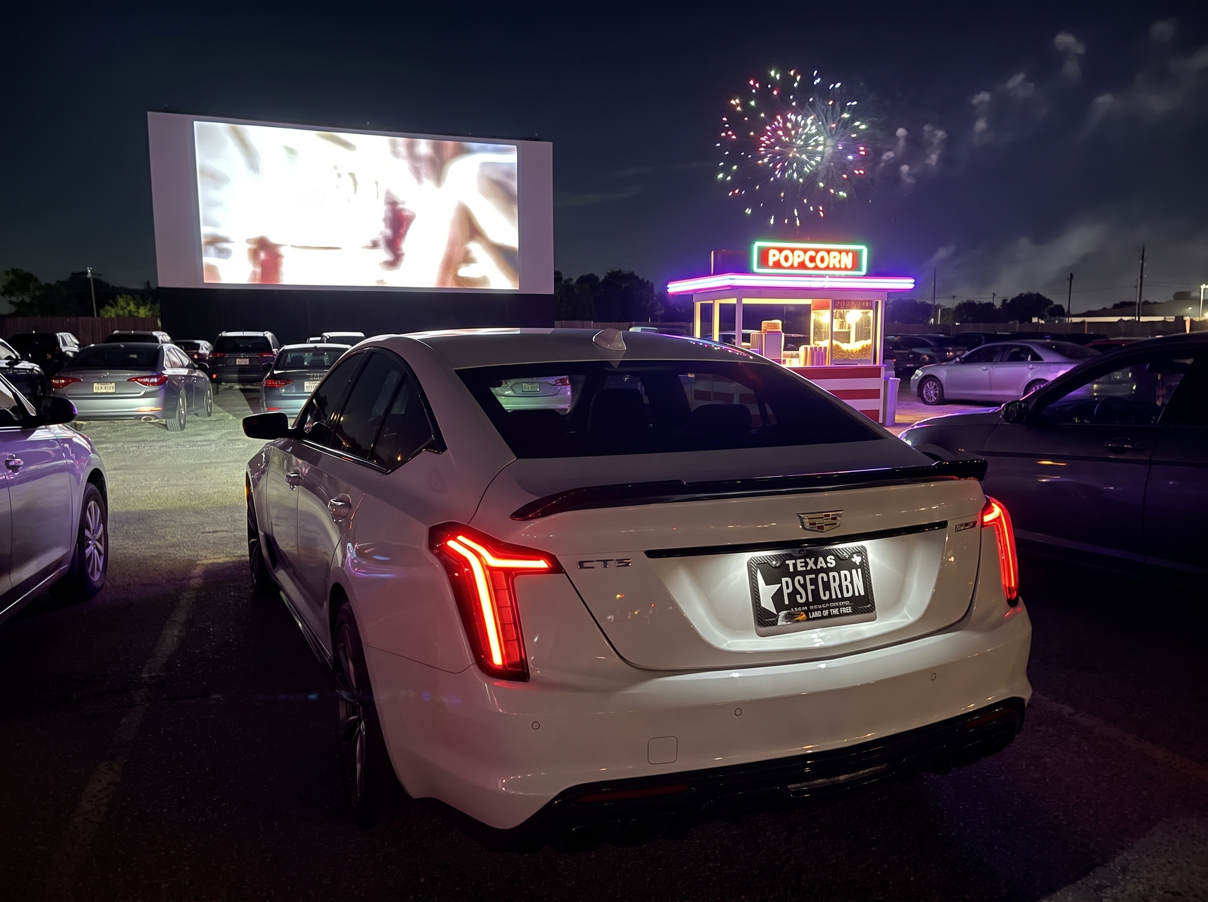 Land of the Free frame at a drive-in with fireworks