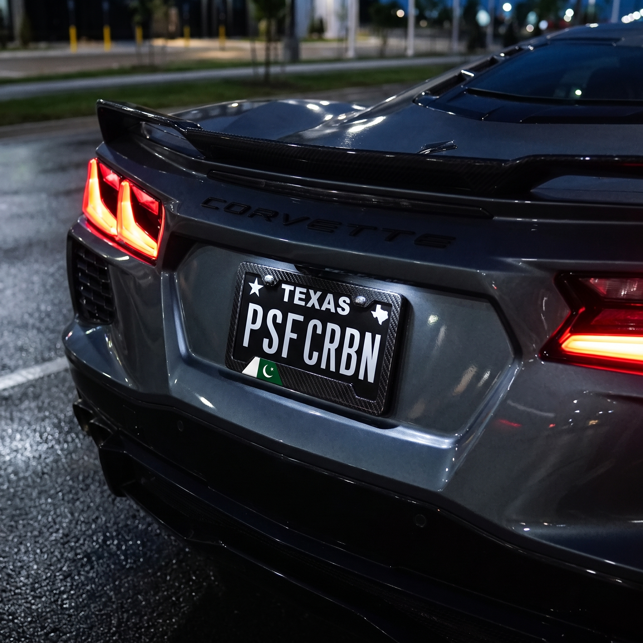Pakistan flag carbon fiber license plate frame on Chevrolet Corvette C8 at night