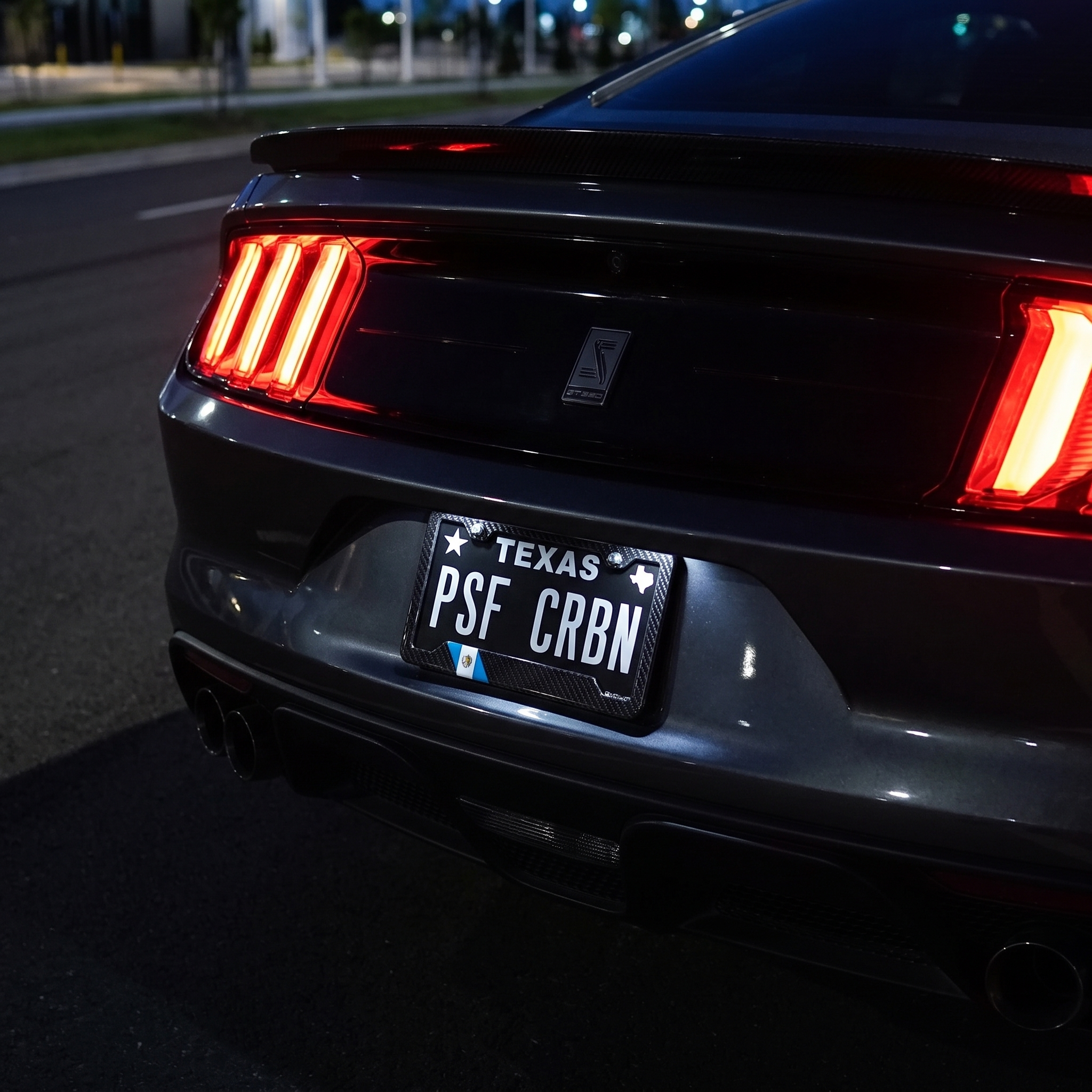 Guatemala flag carbon fiber license plate frame on Ford Mustang Shelby GT350 at night