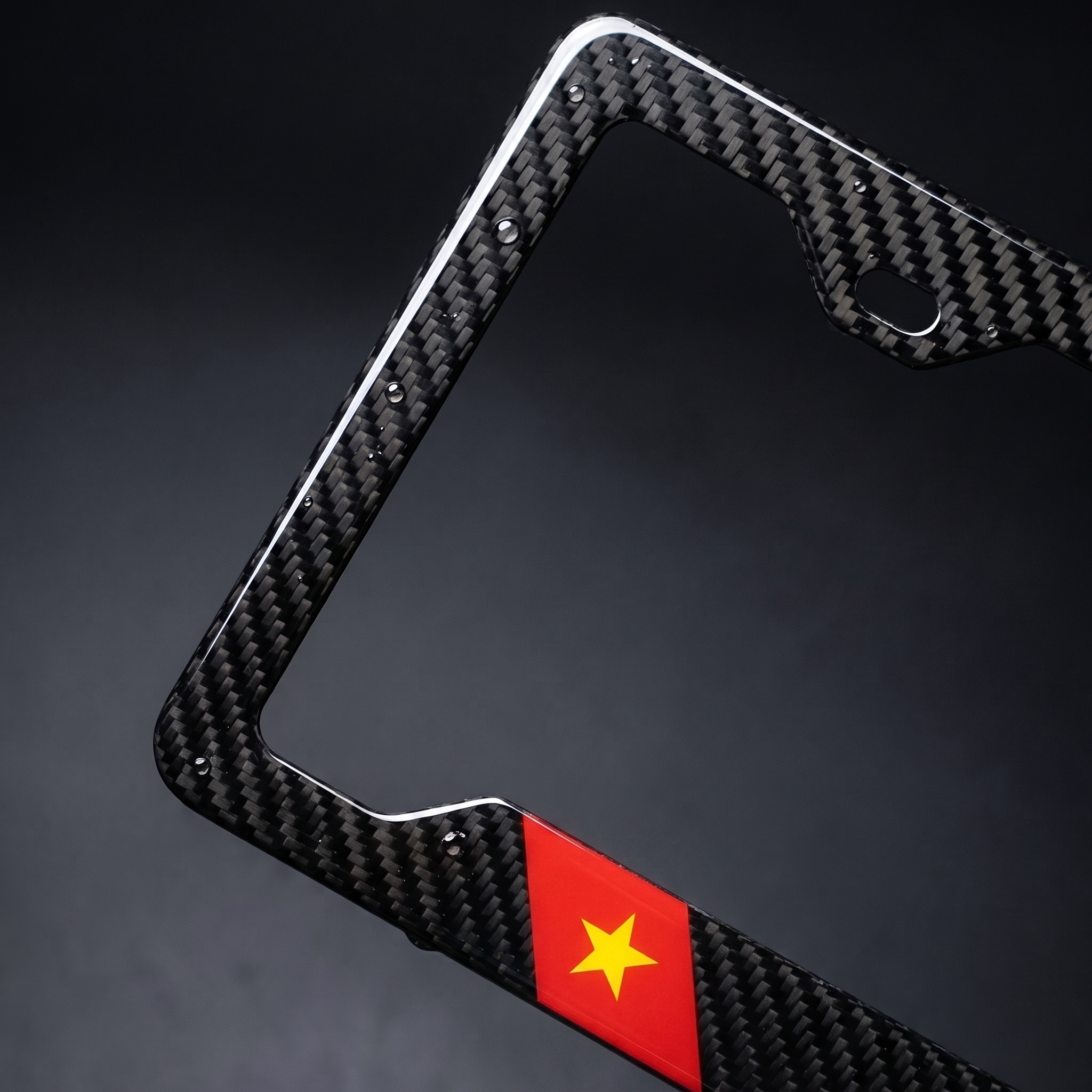 Vietnam flag carbon fiber license plate frame — angled macro