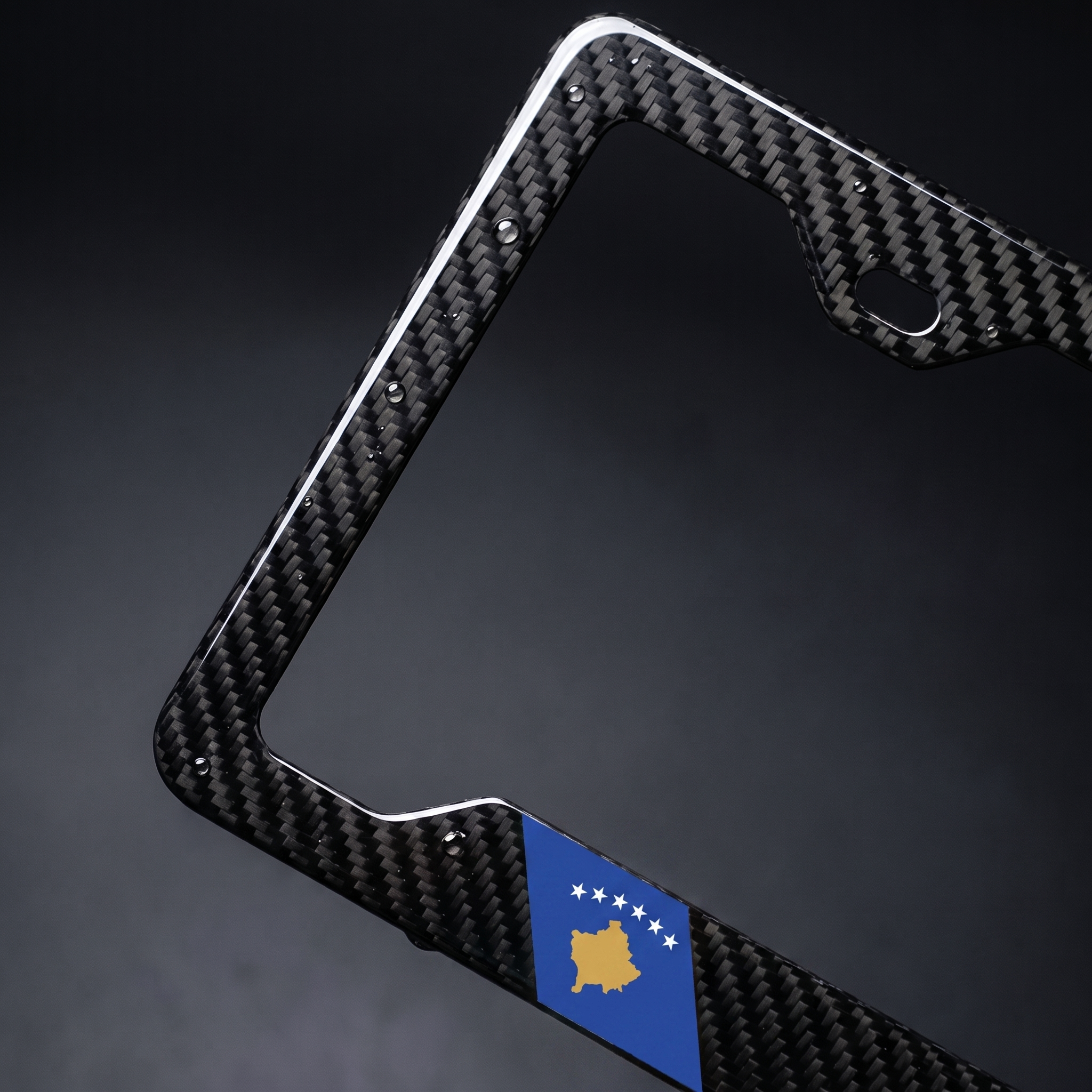 Kosovo flag carbon fiber license plate frame — angled macro