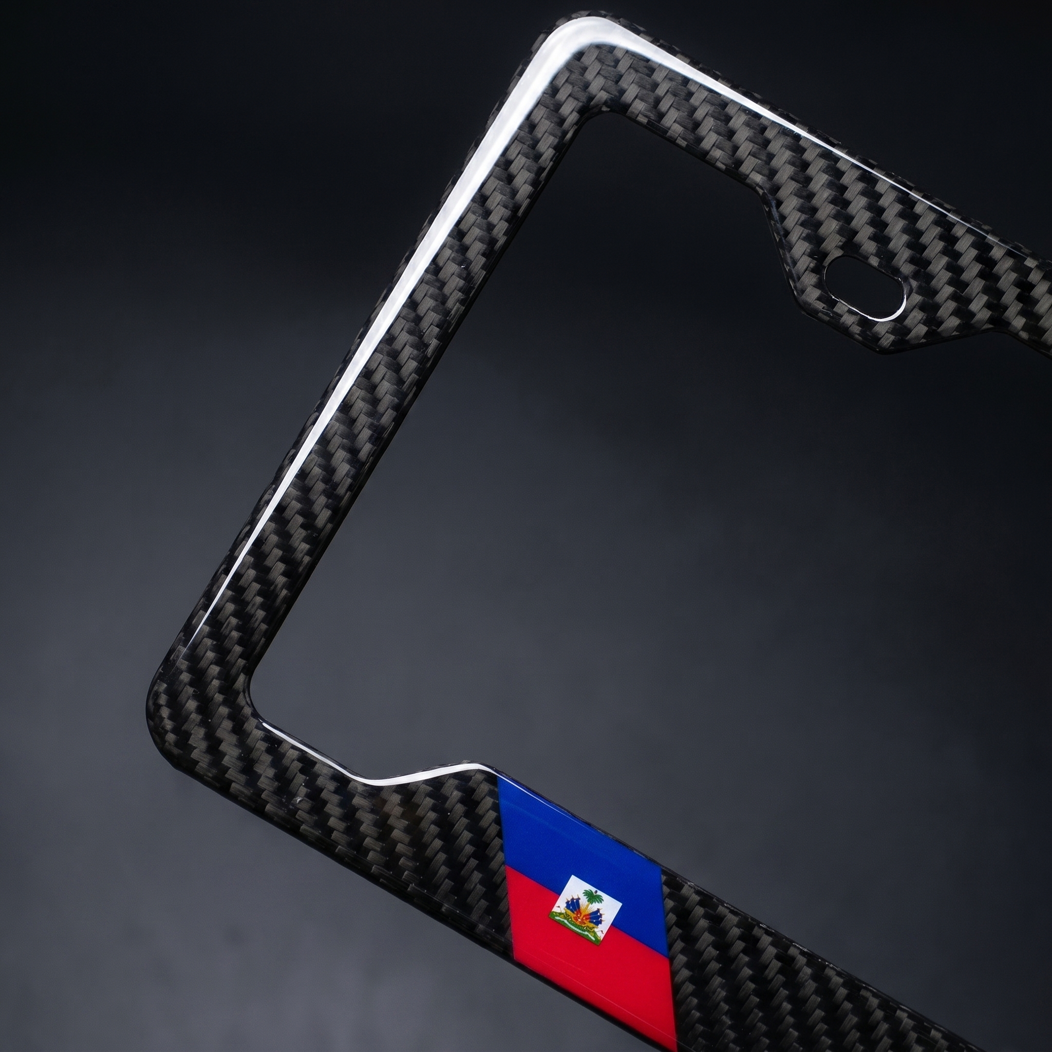 Haiti flag carbon fiber license plate frame — angled corner macro