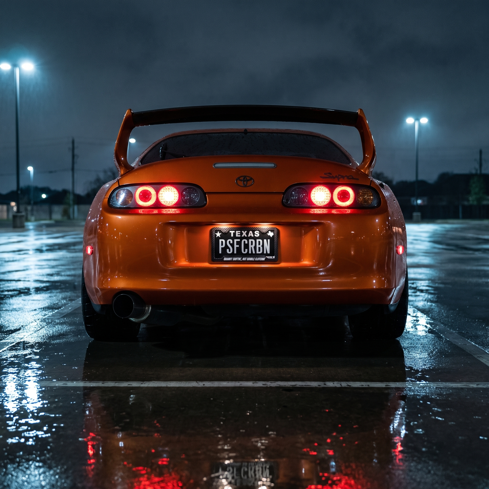 Granny Shiftin', Not Double Clutchin' frame on an orange Toyota Supra Mk4 in a wet night parking lot