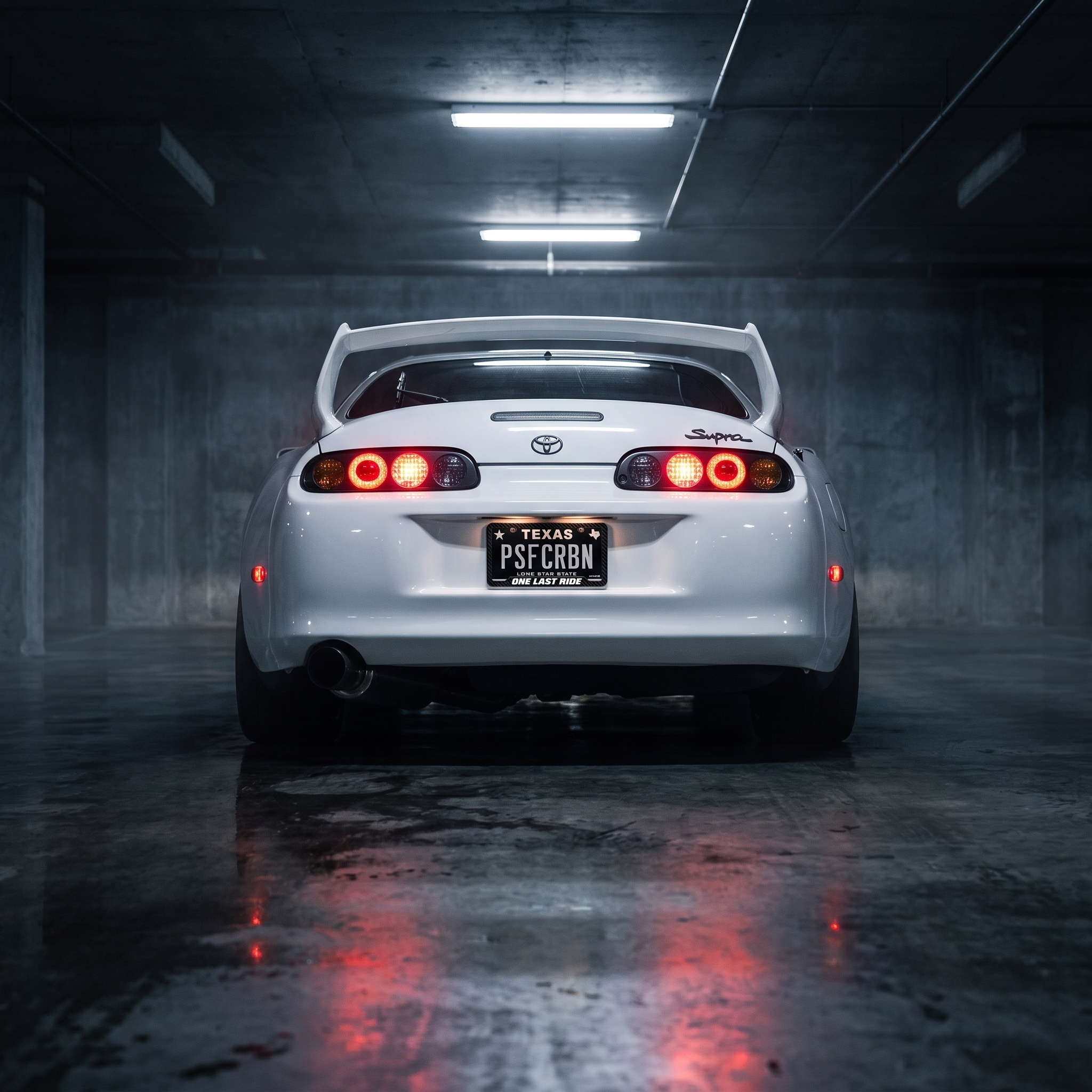 One Last Ride frame on a white Toyota Supra Mk4 in a night garage