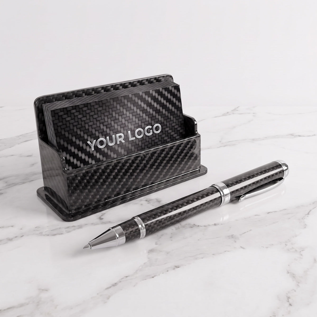 Carbon fiber business card holder and CarbonInk pen on a white marble desk