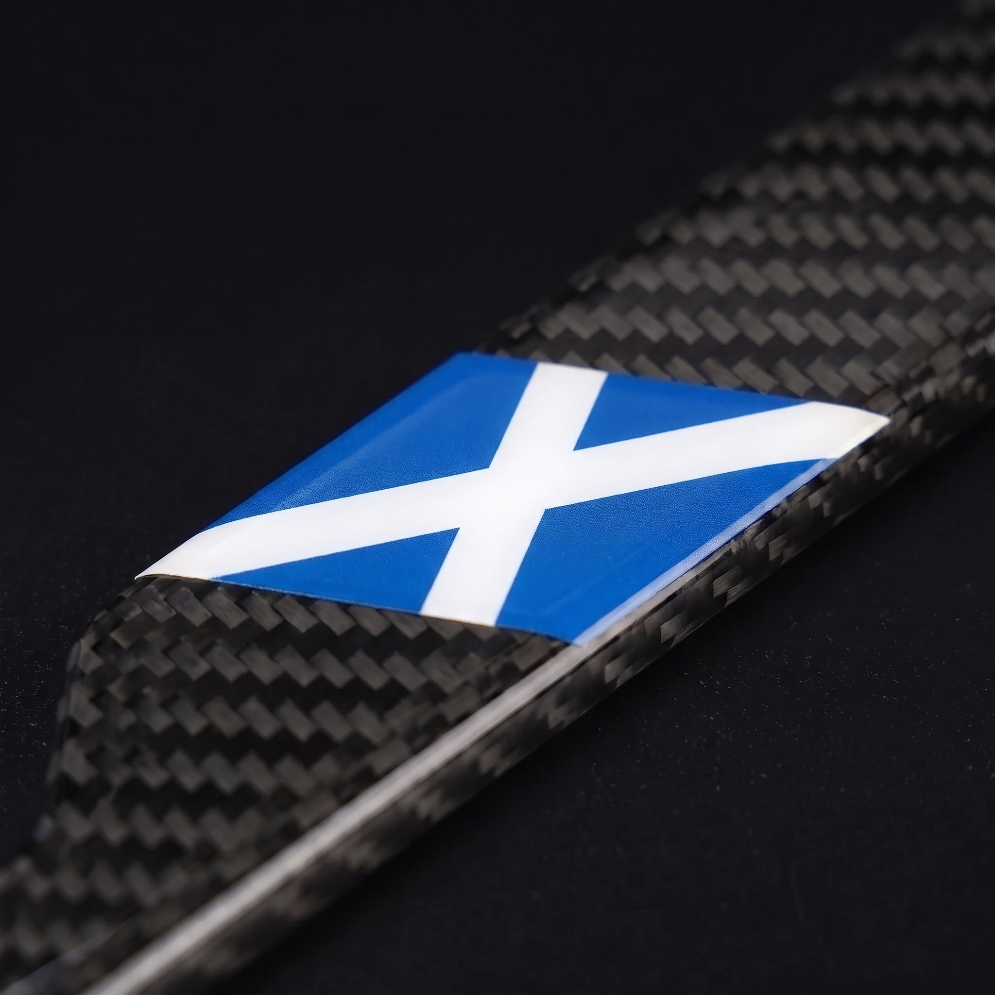 Macro of the Scotland flag inlay on a PSF Carbon carbon fiber license plate frame