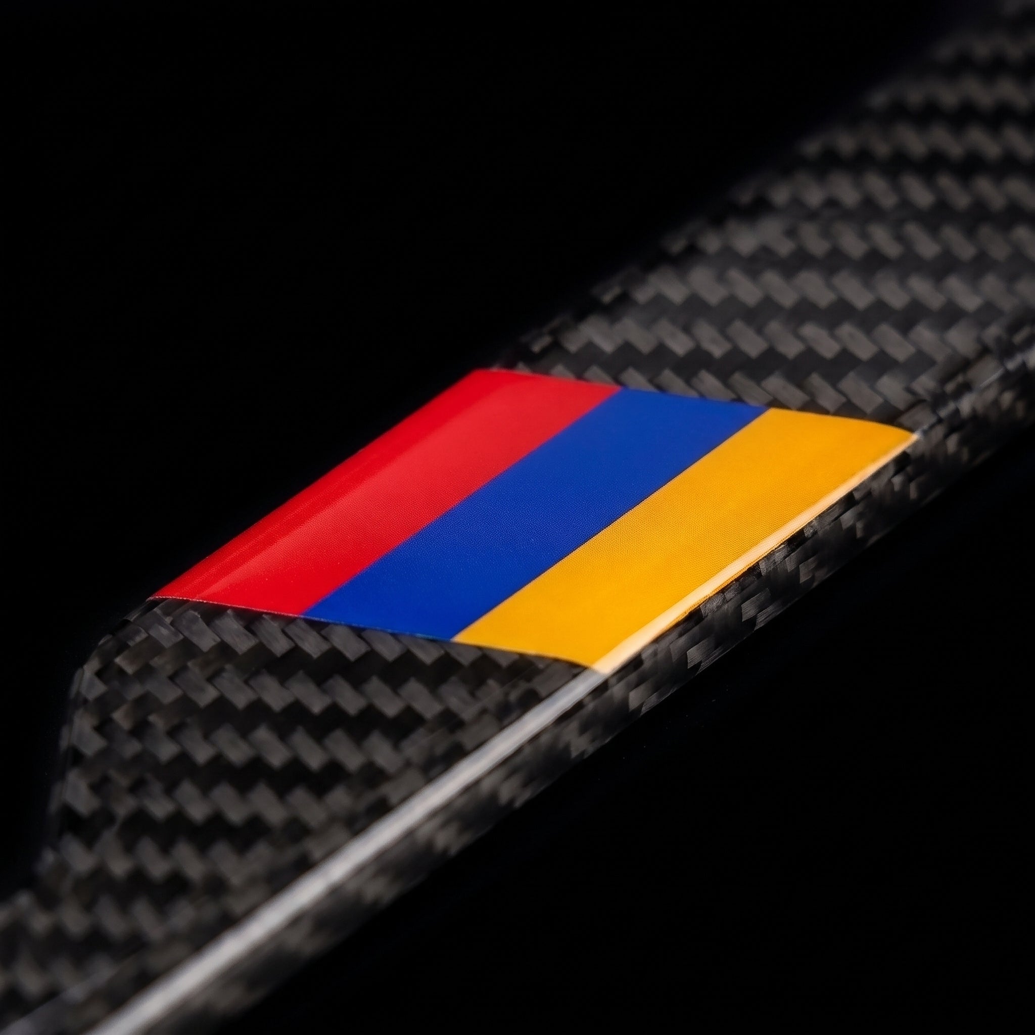 Macro of the Armenia flag inlay on a PSF Carbon carbon fiber license plate frame