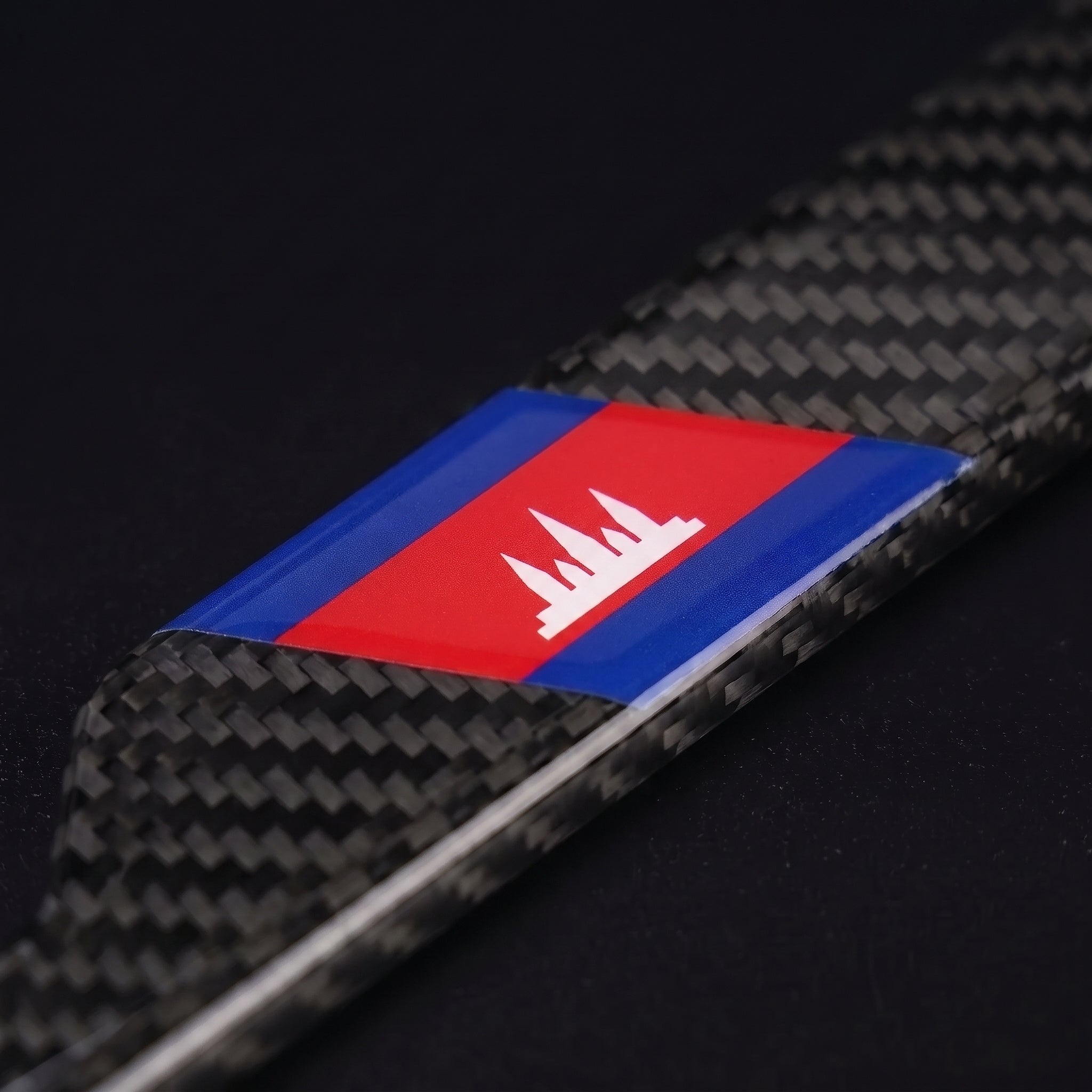 Macro of the Cambodia flag inlay on a PSF Carbon carbon fiber license plate frame
