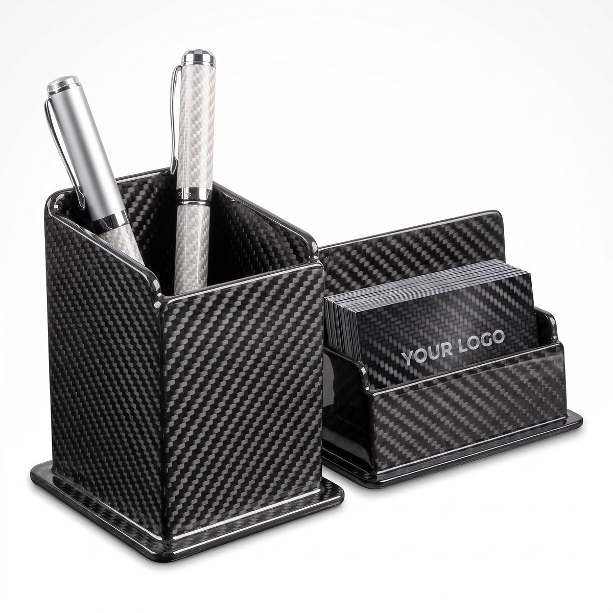 Carbon fiber pen holder with two pens beside the carbon fiber business card holder