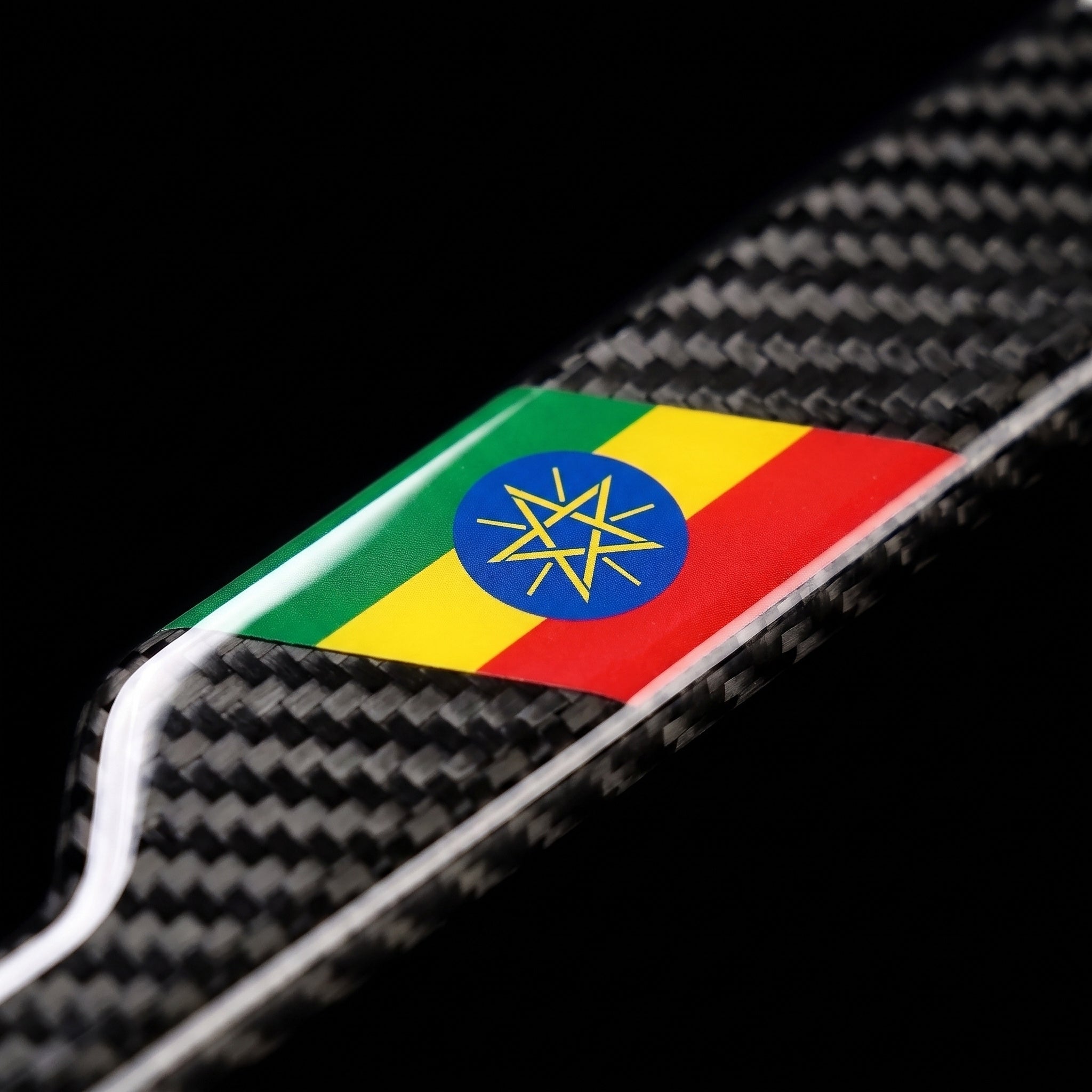 Macro of the Ethiopia flag inlay on a PSF Carbon carbon fiber license plate frame
