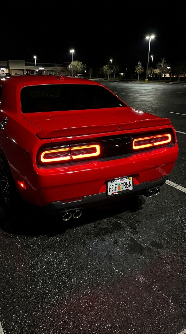 Egypt carbon plate frame on a red Dodge Challenger, taillights on