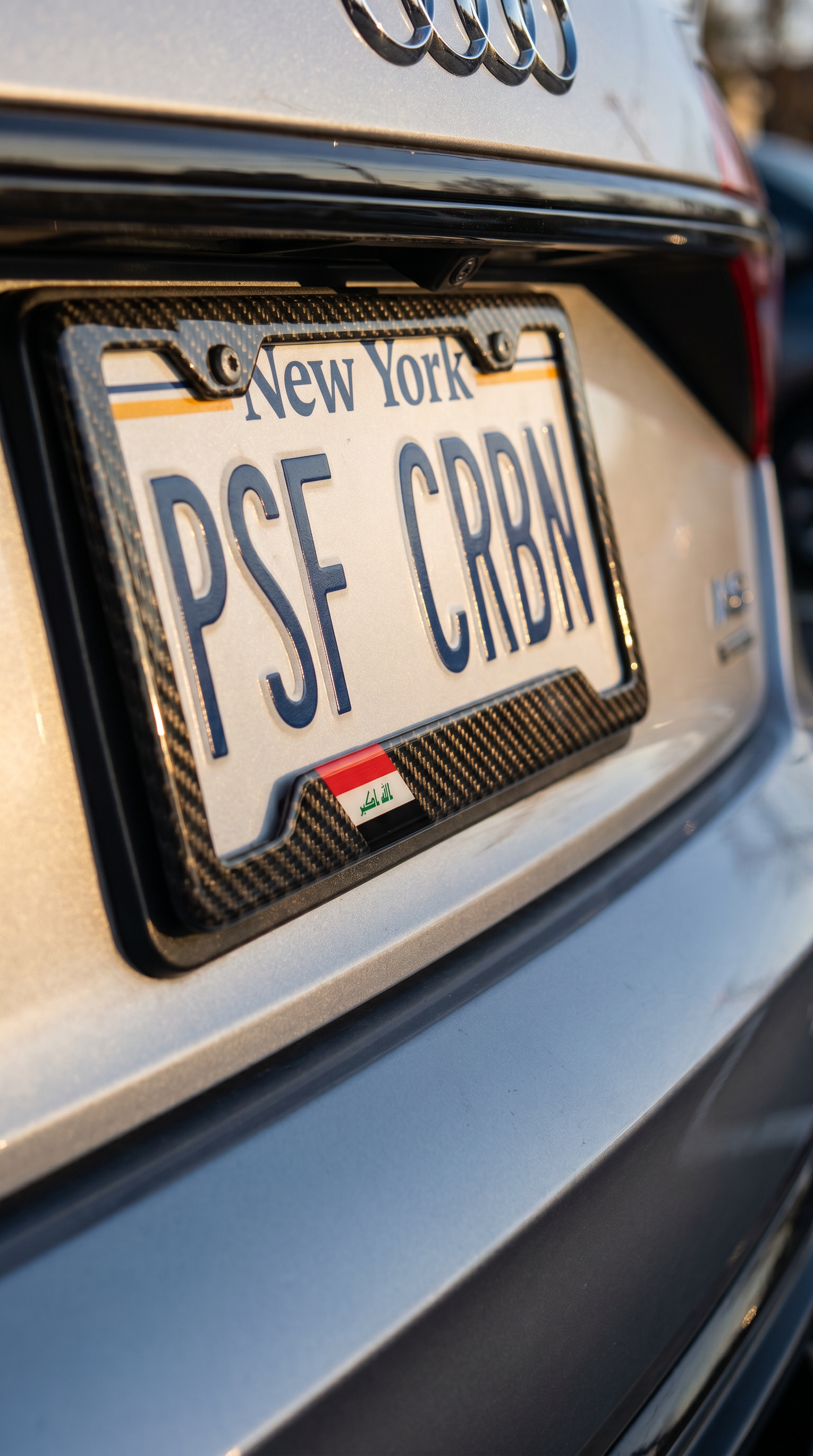 Iraq flag carbon fiber plate frame angled close-up on silver Audi A8