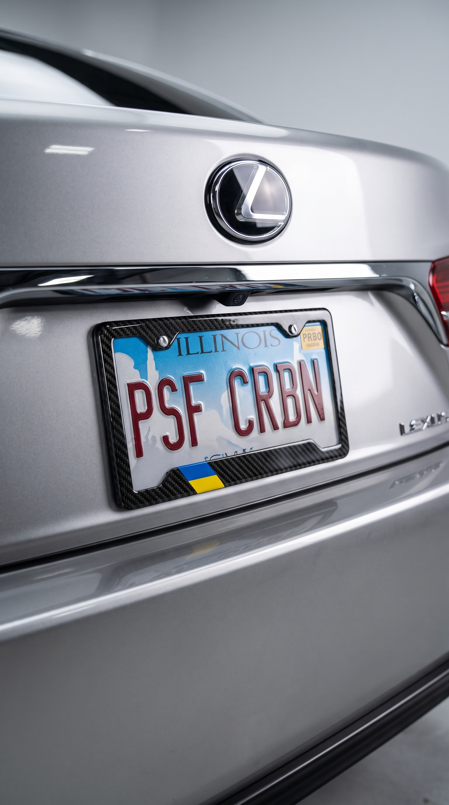 Ukraine flag carbon fiber license plate frame close-up on silver Lexus LS