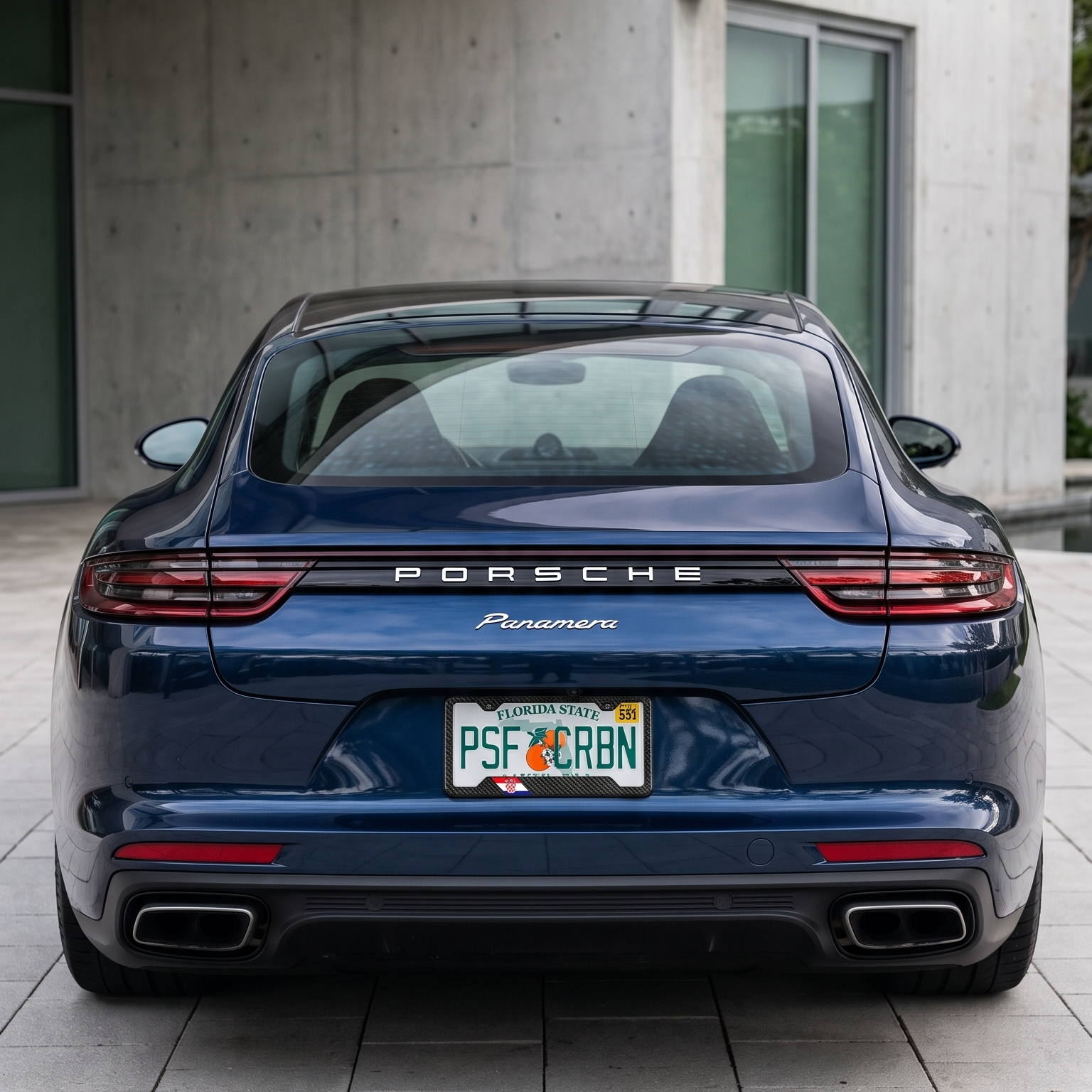 Croatia flag carbon fiber license plate frame on rear of dark blue Porsche Panamera, wide shot