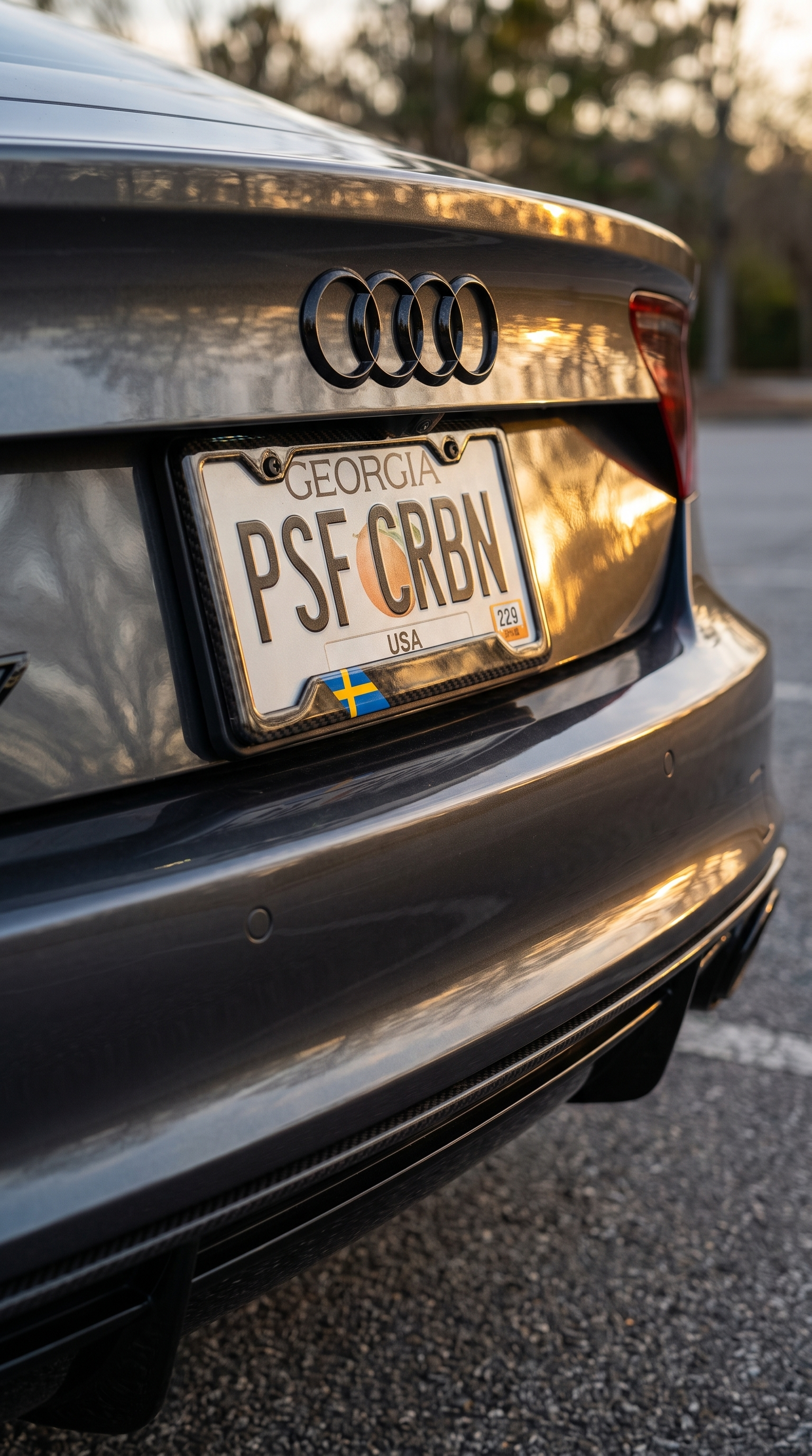 Sweden flag carbon fiber license plate frame three-quarter angle on grey Audi RS7