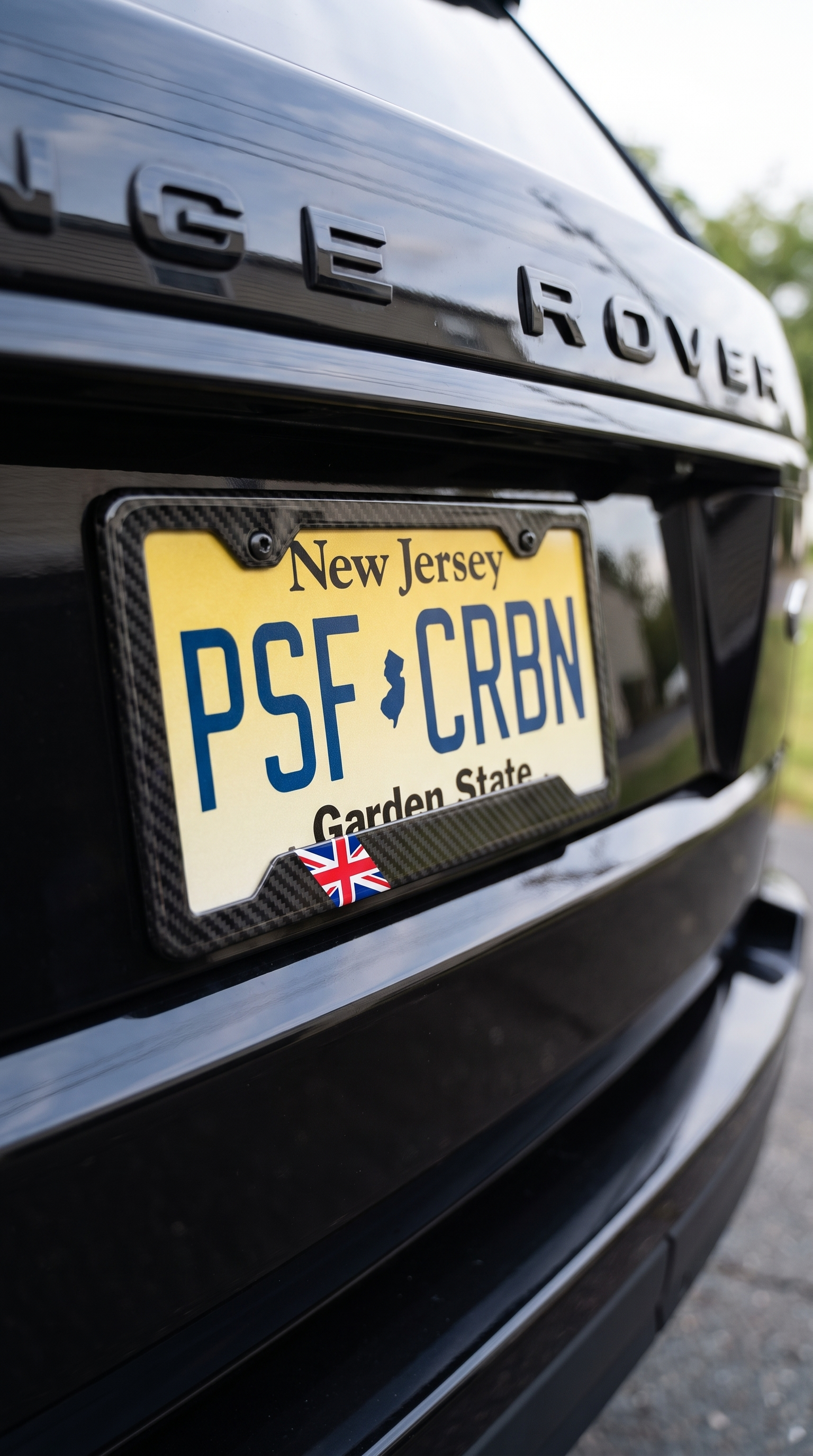UK Union Jack carbon fiber license plate frame on Range Rover, close-up, New Jersey plate PSF CRBN