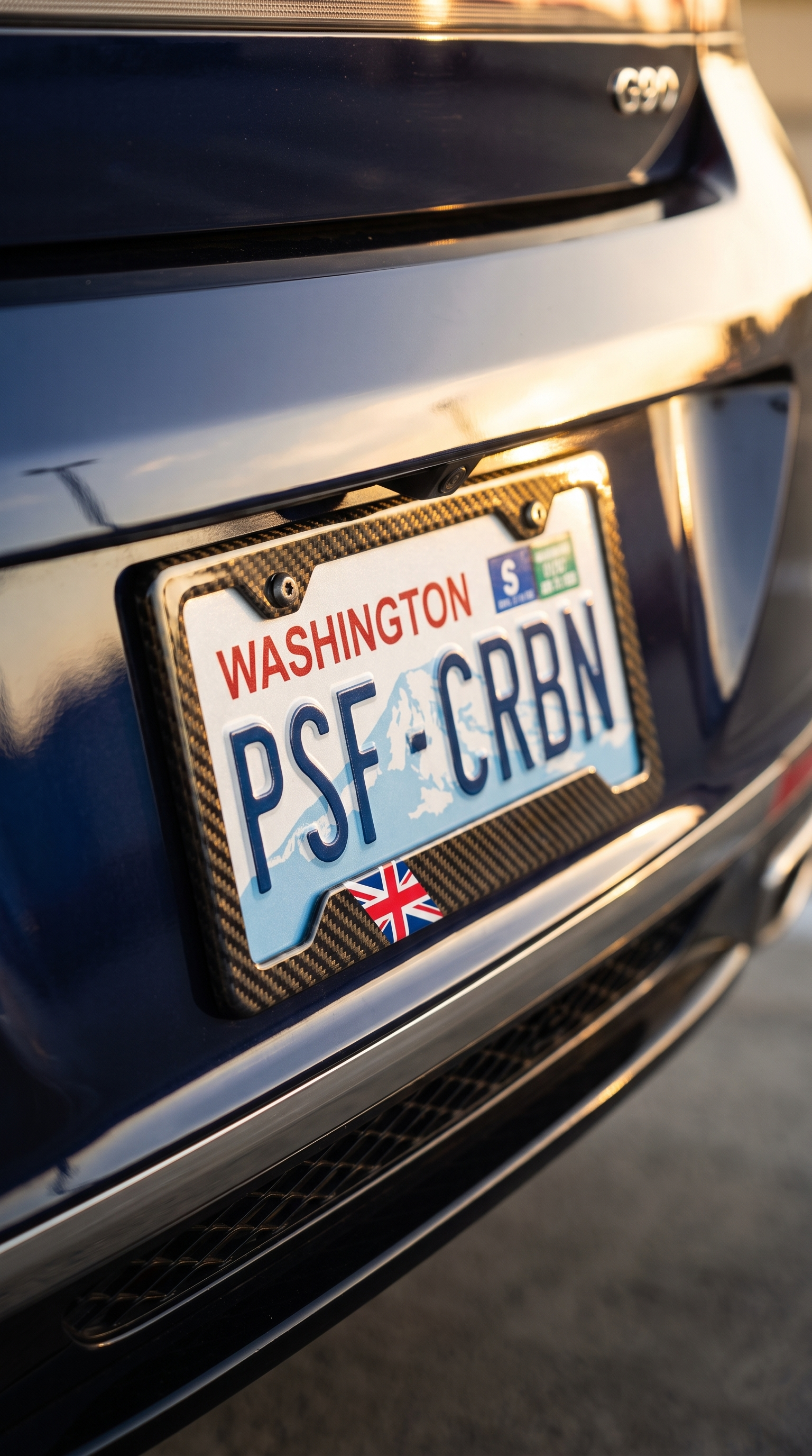 UK Union Jack carbon fiber license plate frame on Genesis G90, three-quarter angle, Washington plate PSF CRBN
