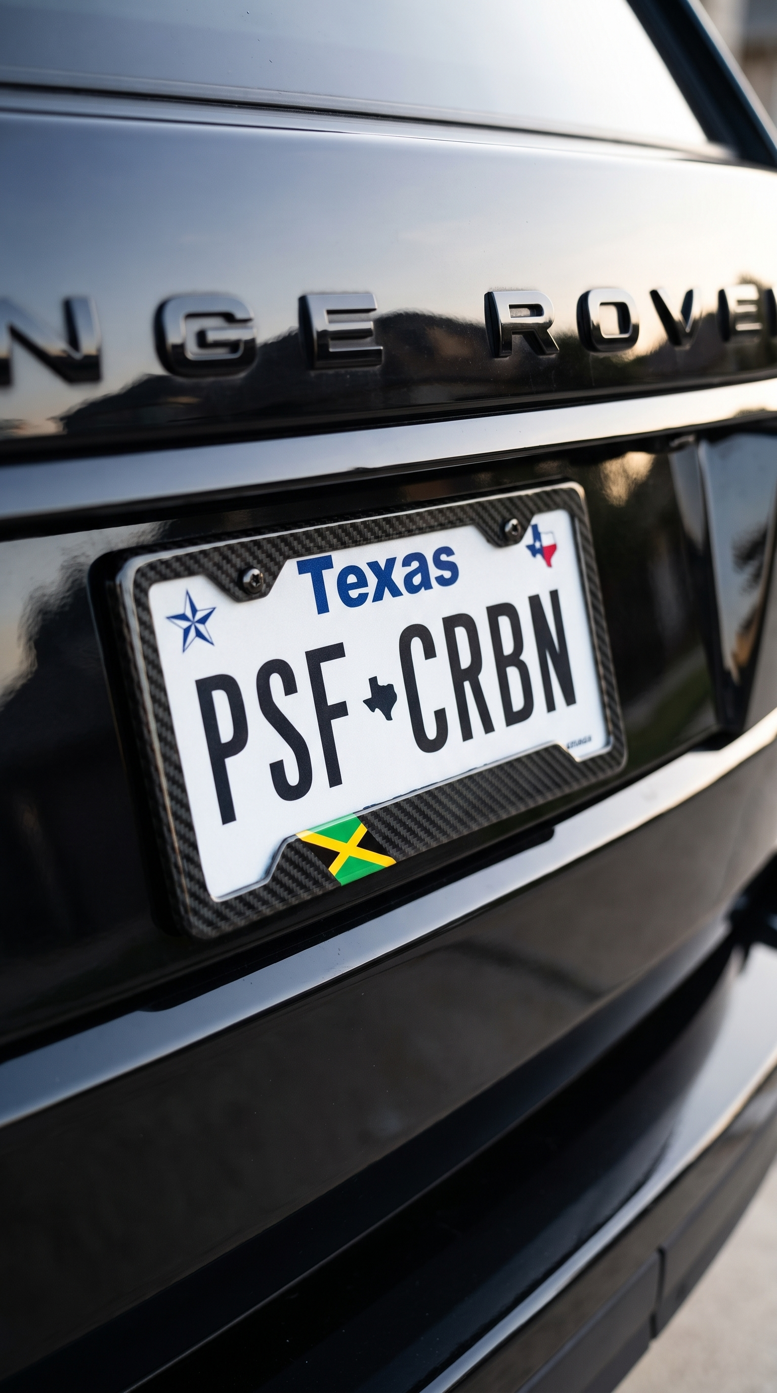 Jamaica flag carbon fiber plate frame close-up on black Range Rover, Texas plate PSF CRBN