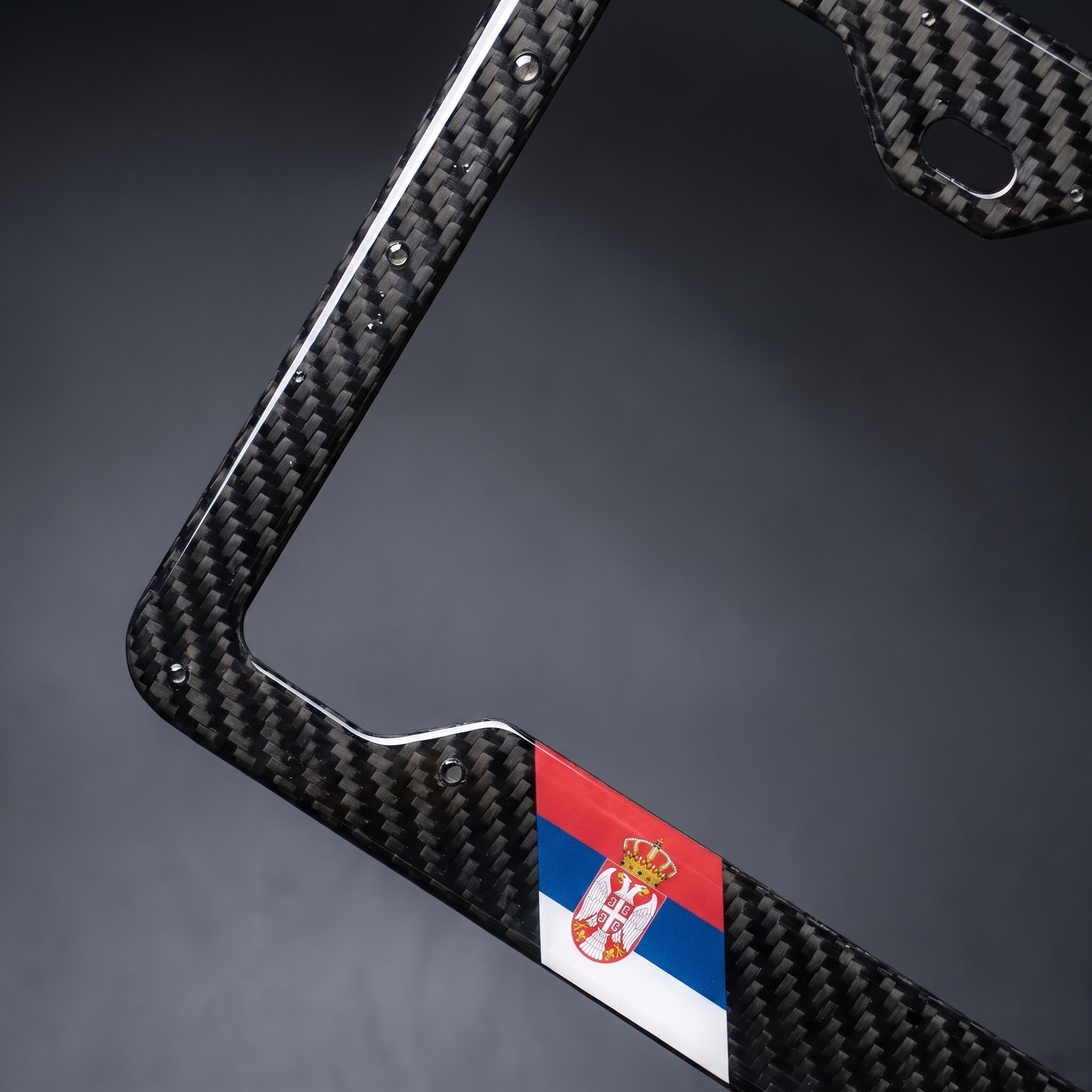 Serbia flag carbon fiber license plate frame — angled macro