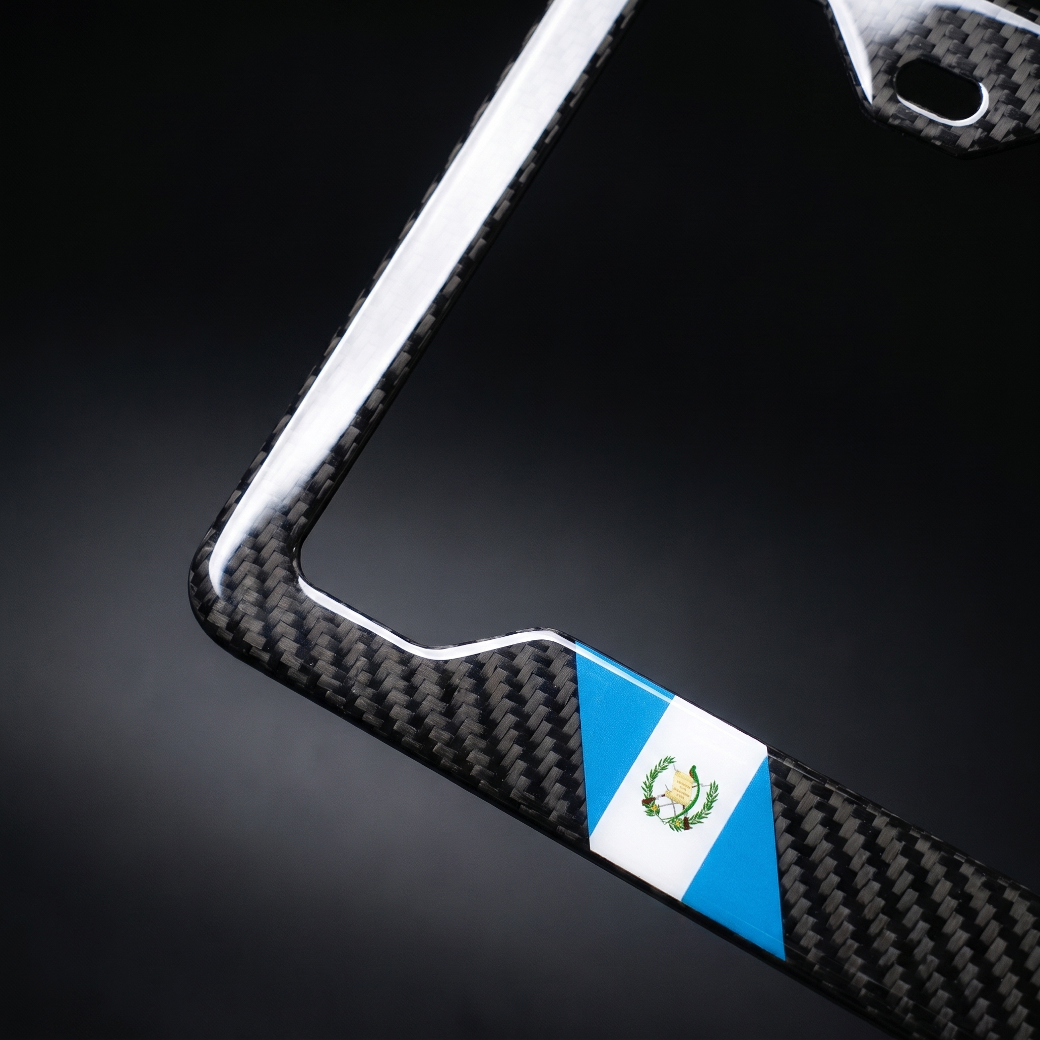 Guatemala flag carbon fiber license plate frame — angled corner macro