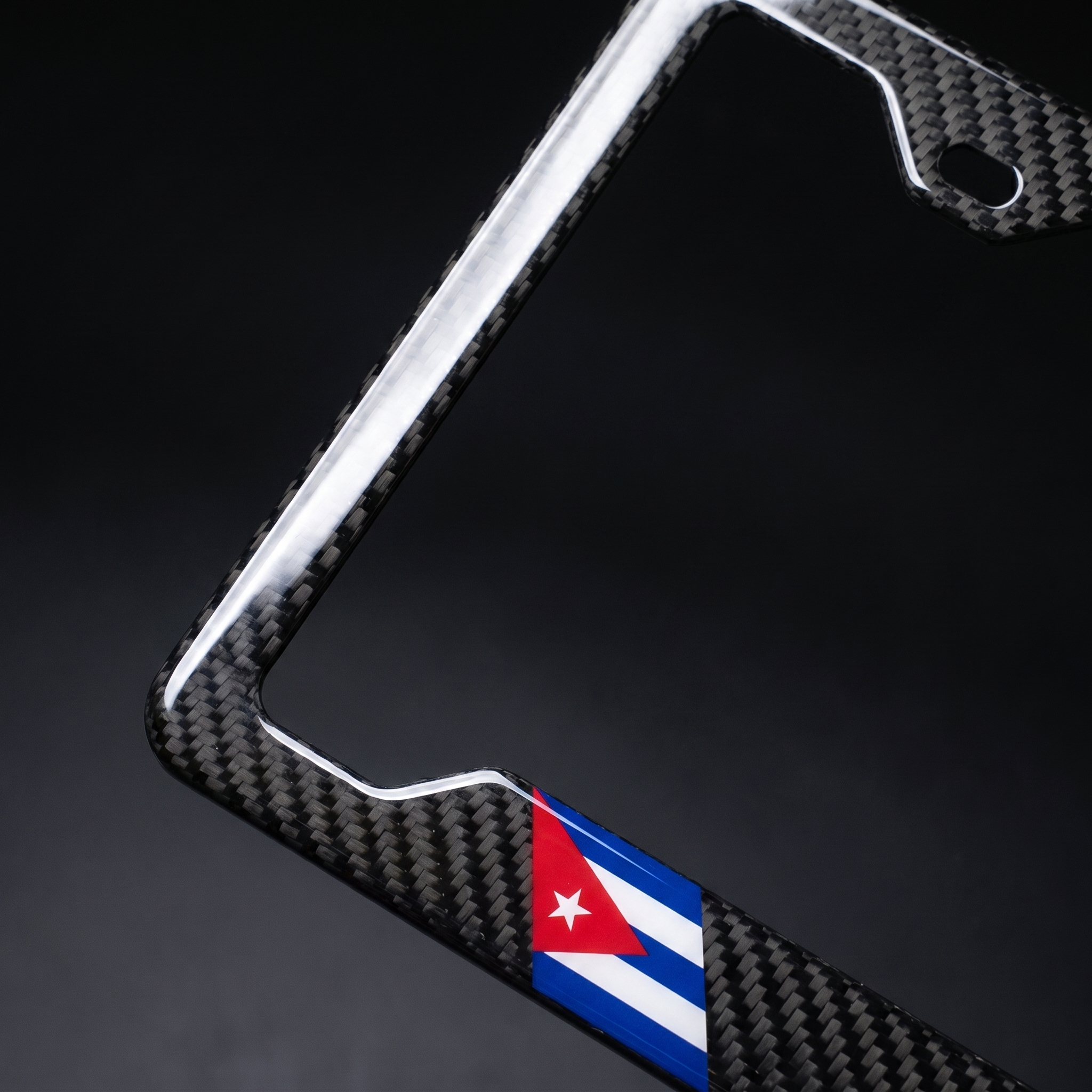 Cuba flag carbon fiber license plate frame — angled corner macro