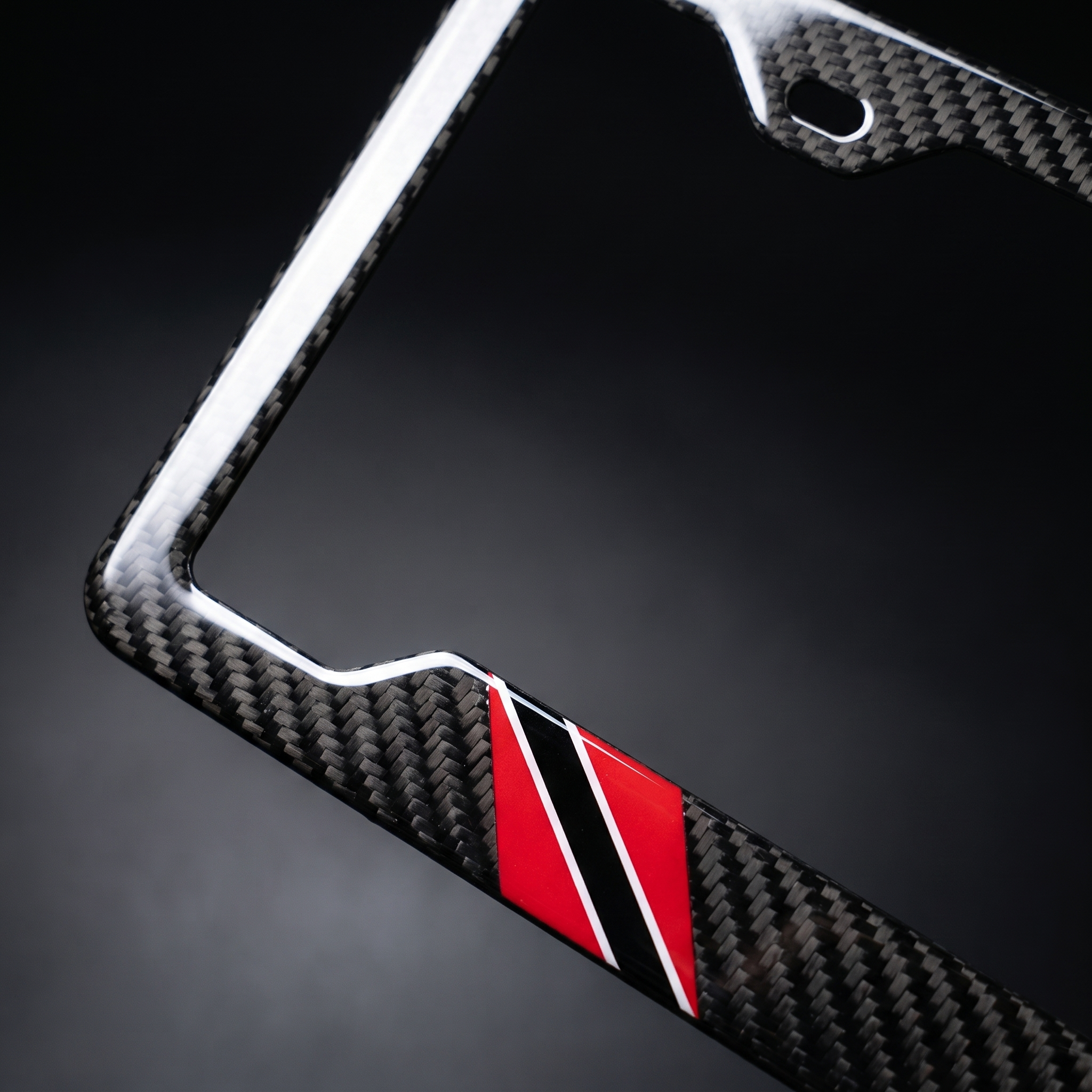 Trinidad & Tobago flag carbon fiber license plate frame — angled corner macro