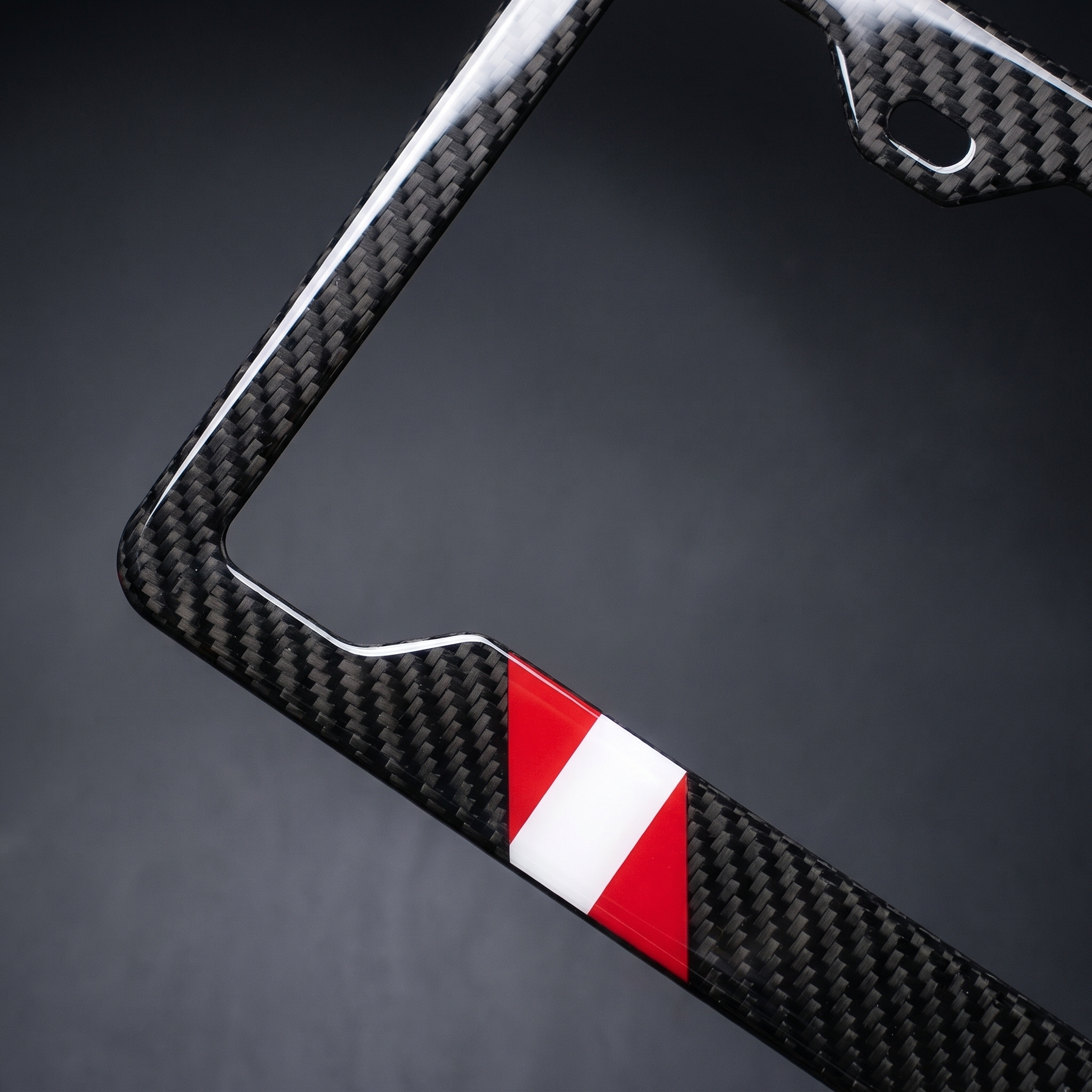 Peru flag carbon fiber license plate frame — angled corner macro