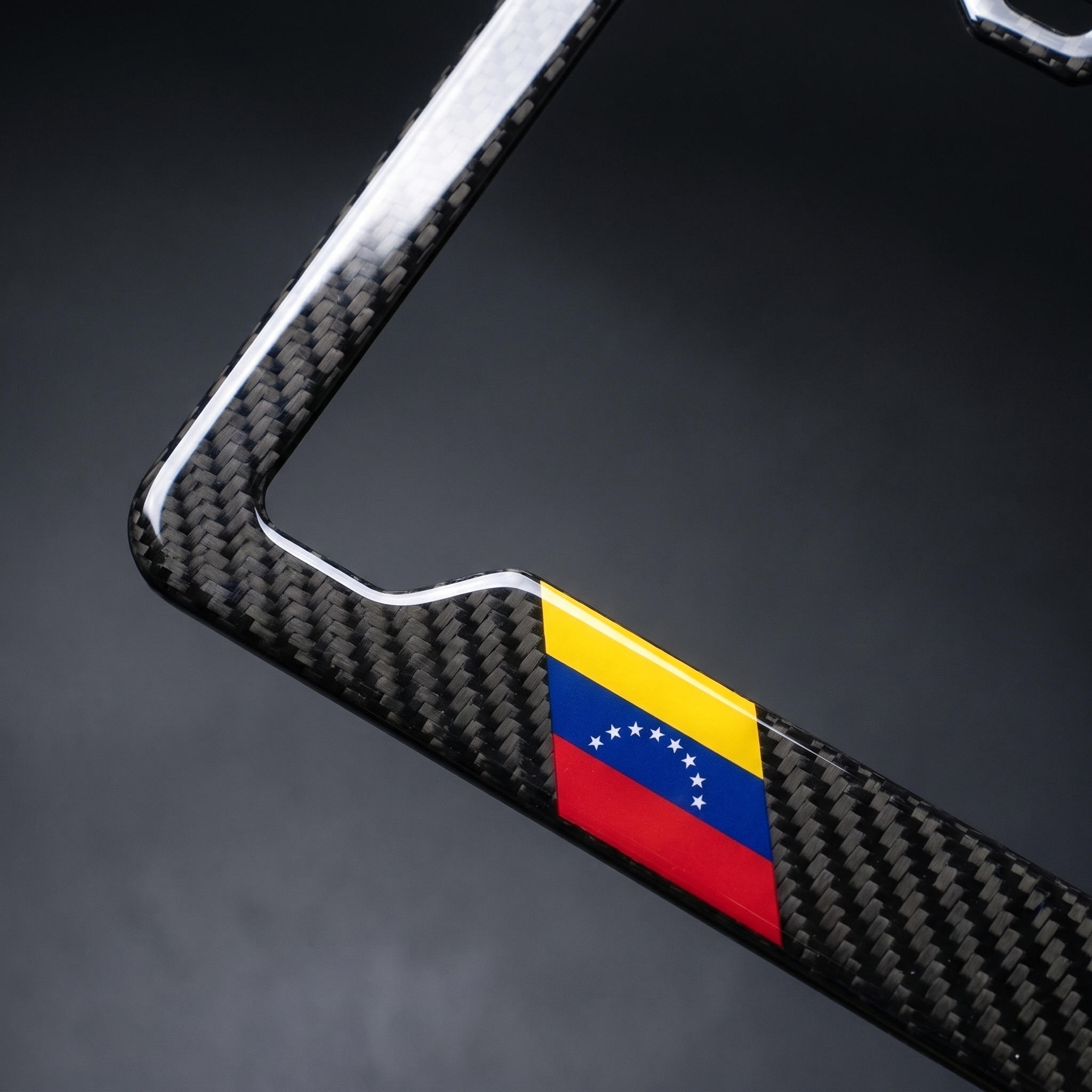 Venezuela flag carbon fiber license plate frame — angled corner macro