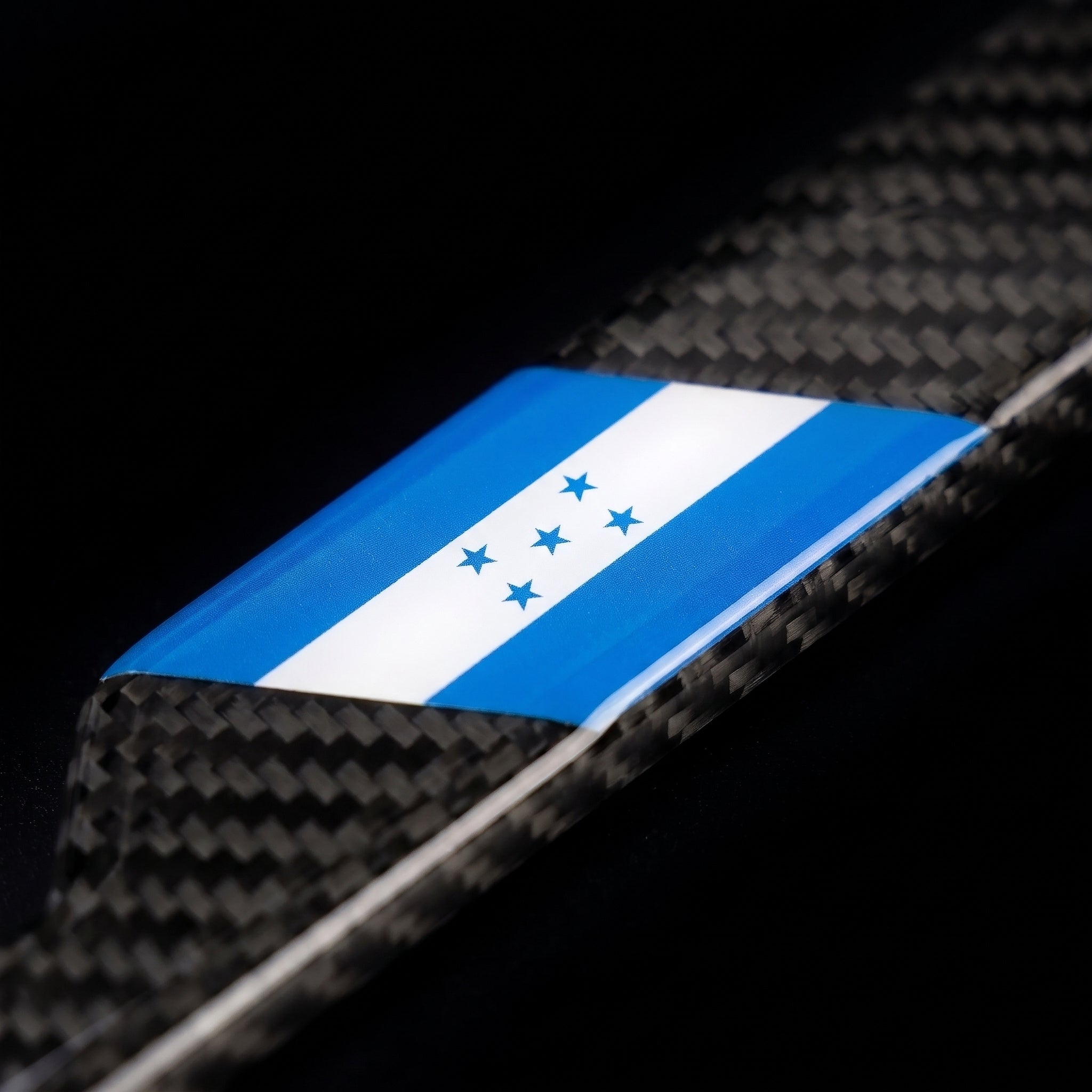 Macro of the Honduras flag inlay on a PSF Carbon carbon fiber license plate frame