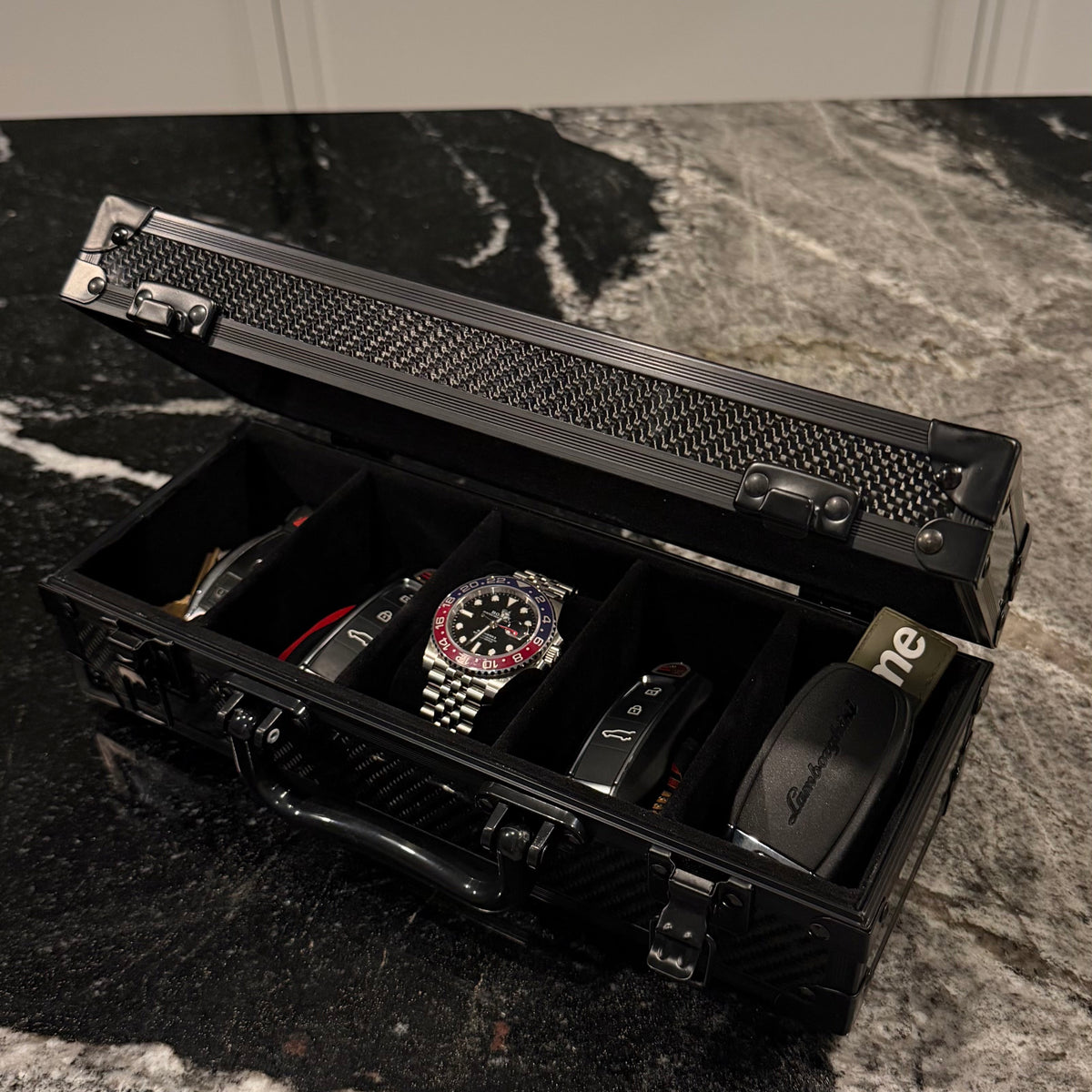 The Motorcase 5 Slot open with keys, black suede interior #Colour_Black