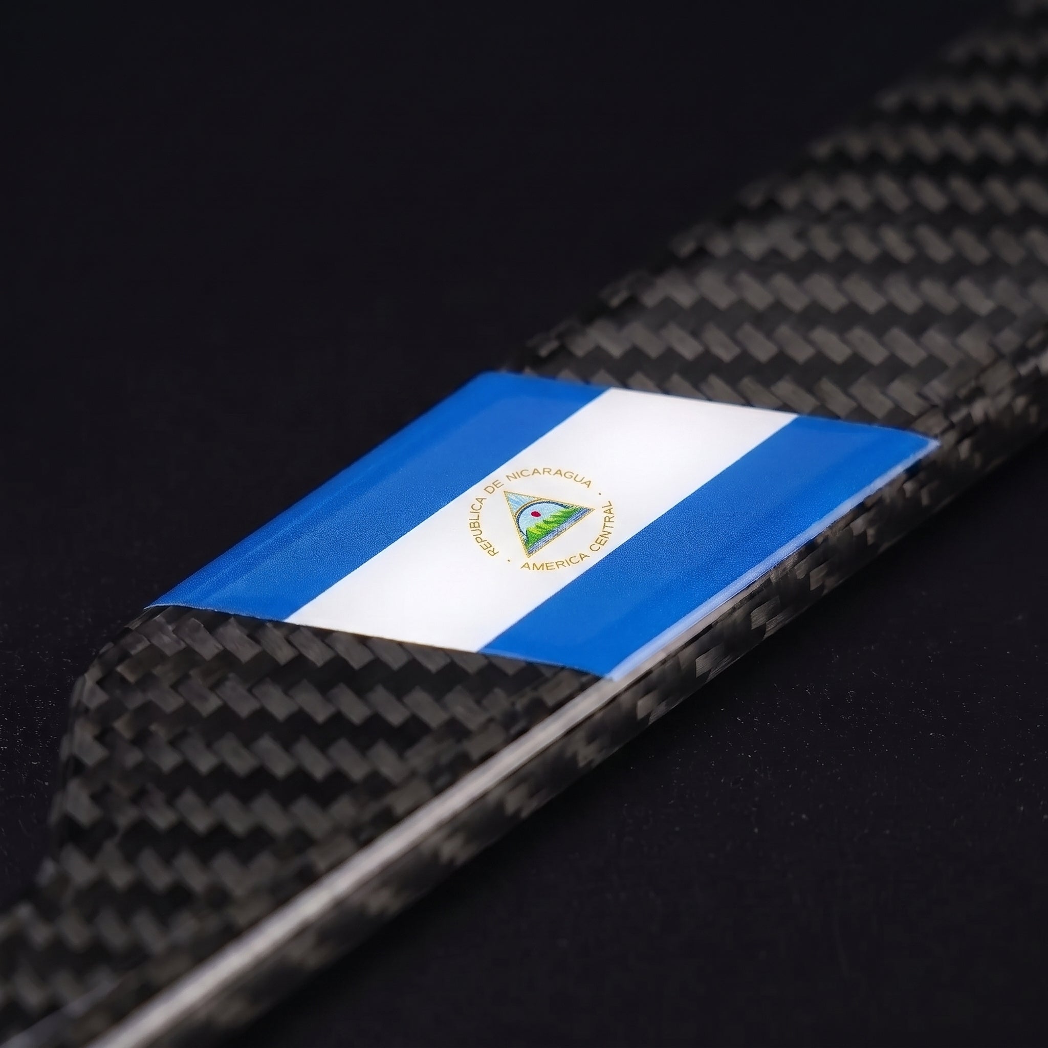 Macro of the Nicaragua flag inlay on a PSF Carbon carbon fiber license plate frame