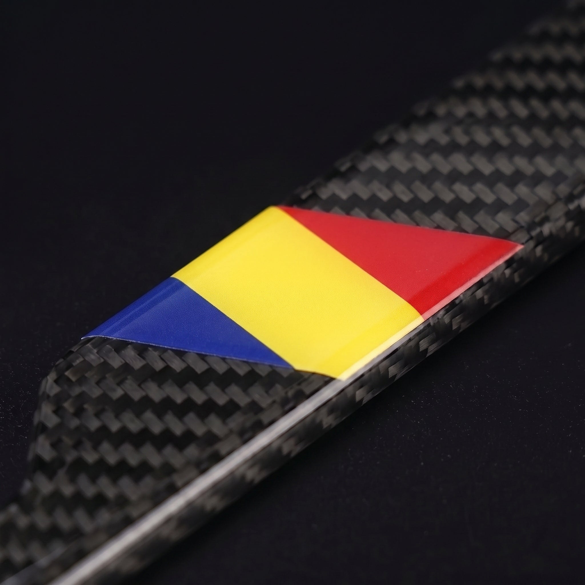 Macro of the Romania flag inlay on a PSF Carbon carbon fiber license plate frame