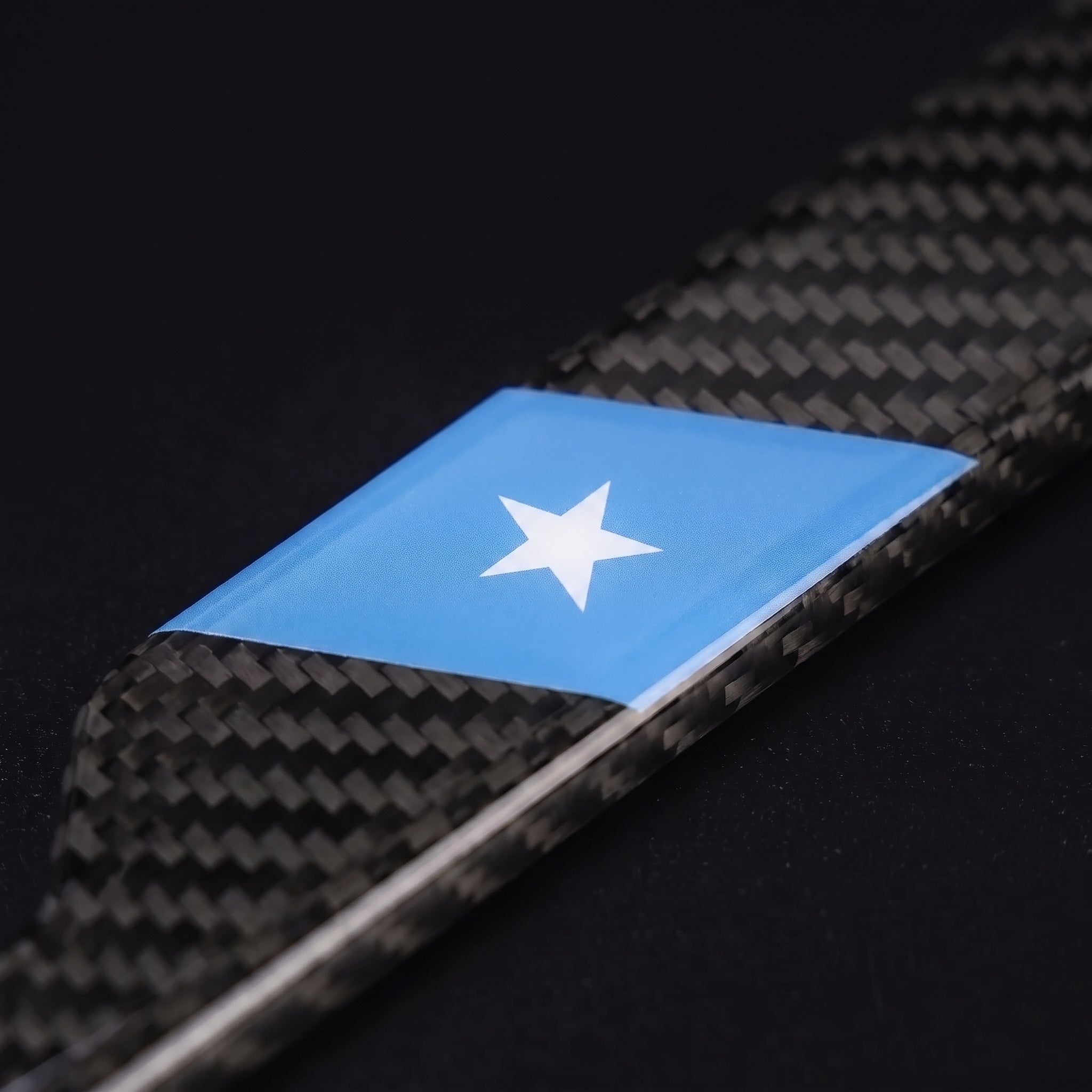 Macro of the Somalia flag inlay on a PSF Carbon carbon fiber license plate frame